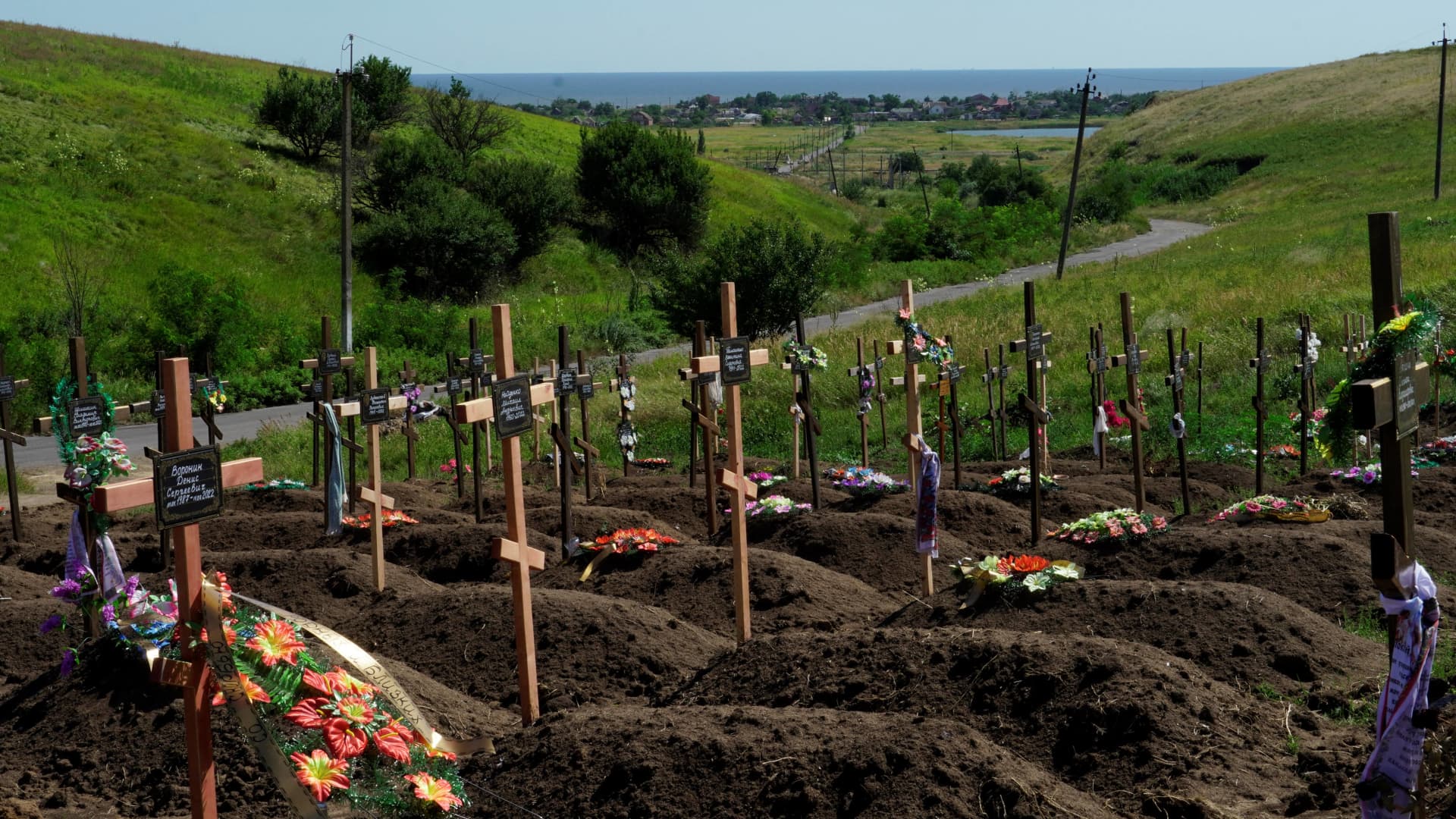 This photograph taken on July 15, 2022, shows recently made graves at a cemetery in the Vinogradnoe district, Donetsk region, amid the ongoing Russian military action in Ukraine.