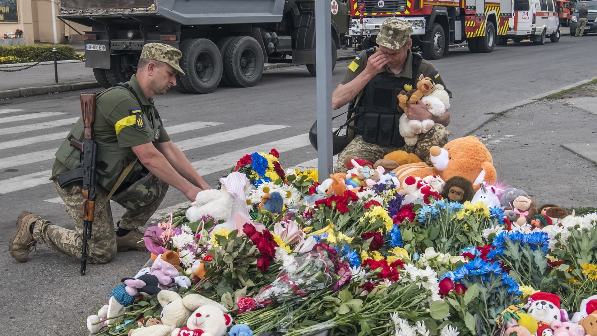 Ukrainian servicemen lay flowers and toys at a place where 4-years-old girl Liza was killed by a Russian cruise missile strike. Vinnytsia, Ukraine July 15, 2022.