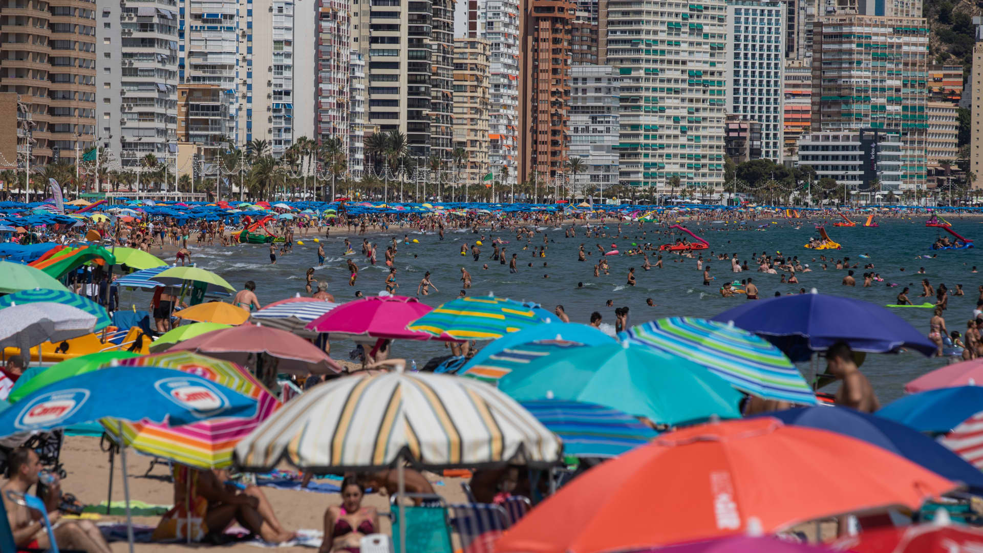 Tourists fill the Levante beach in Benidorm to quench high temperatures as a heatwave sweeps across Spain on July 16, 2022 in Benidorm, Spain. 