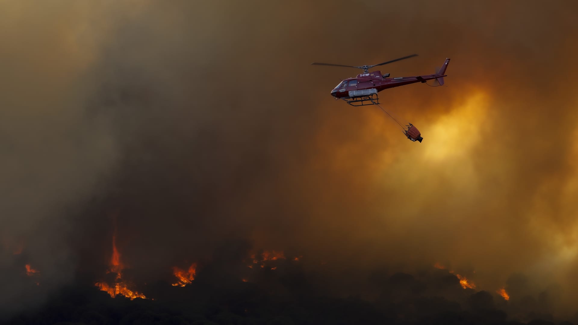 A helicopter works during a forest fire in Cebreros on July 18, 2022 in Avila, Spain.