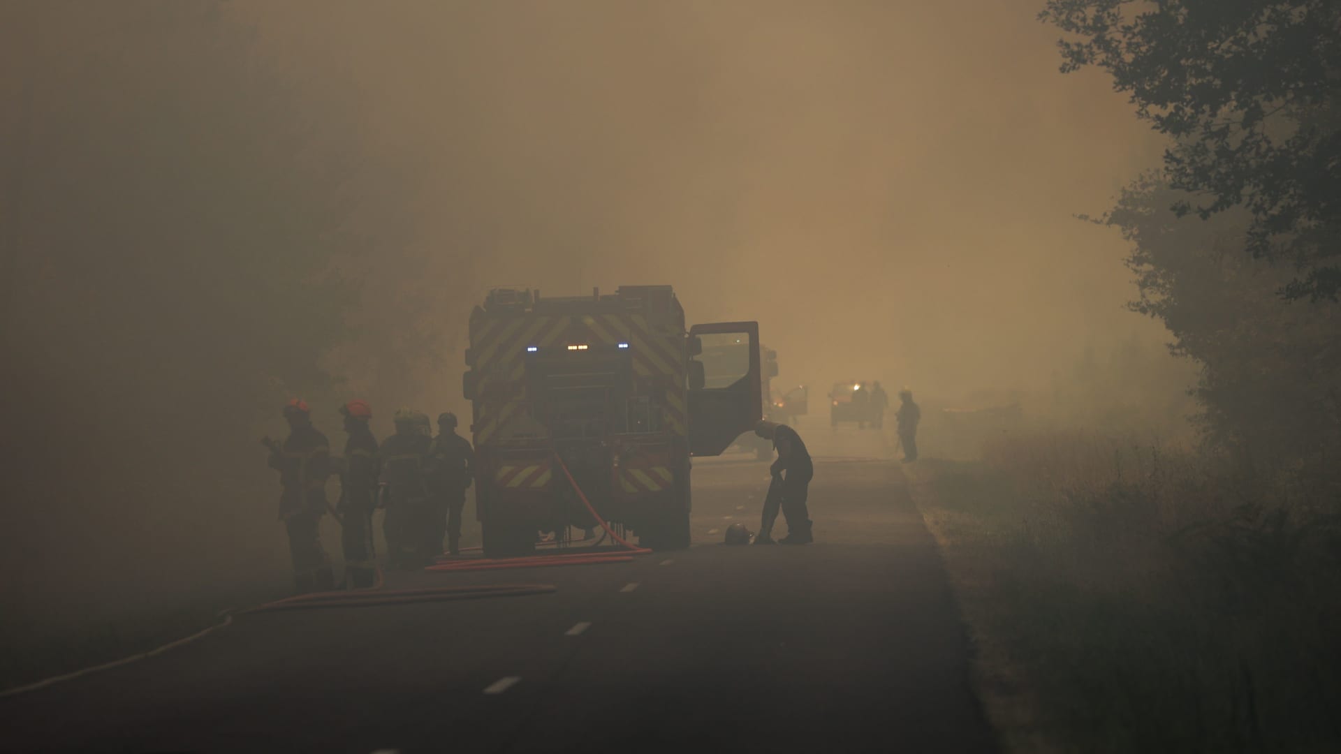 Firefighters try to control a forest fire near Louchats in Gironde, southwestern France on July 17, 2022.