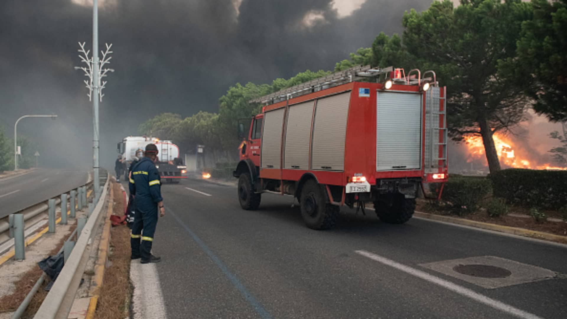 Firefighters prepare to operate as the wildfire approaches in the region of Pallini. A wildfire rages for a second day in Mount Penteli near Athens in Greece causing extensive property damages.