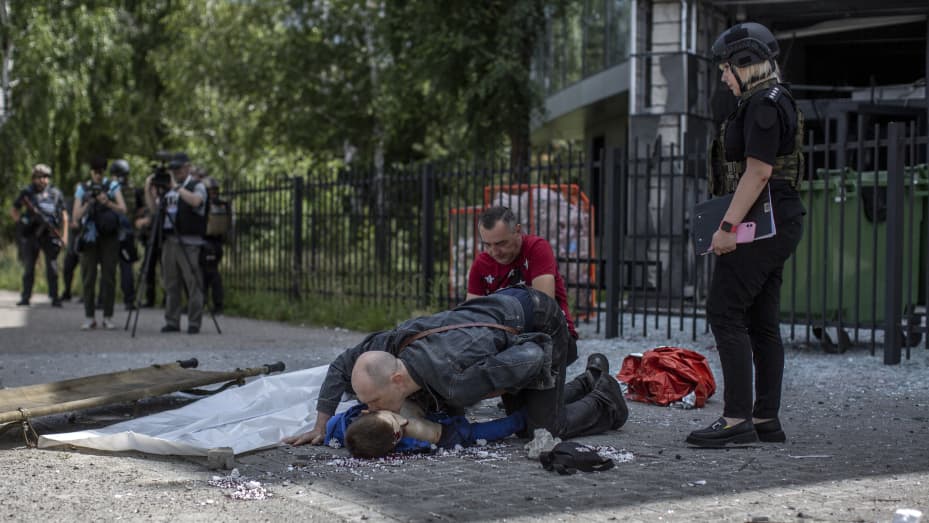 (EDITORS NOTE: Image depicts death) A father kisses the body of his son who was killed during a shelling attack in Saltivka neighborhood in northern of Kharkiv City, Ukraine, July 20th, 2022. (Photo by Narciso Contreras/Anadolu Agency via Getty Images)