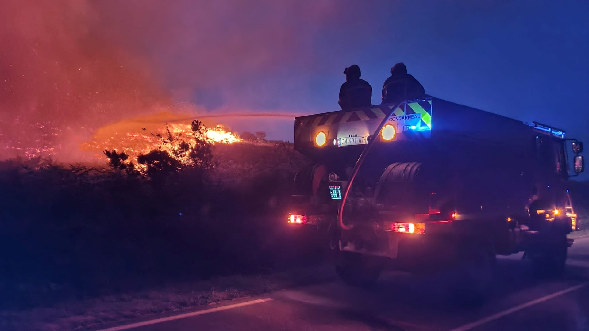Firefighters work during a fire that broke out in the Monts d'Arree in Brasparts, in Brittany, France, July 19, 2022 in this handout picture obtained on July 20, 2022. 