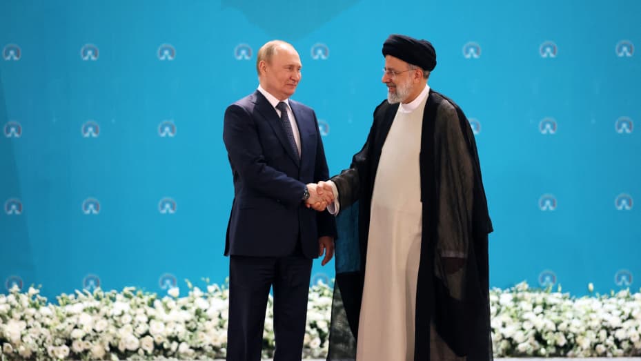 Iranian President Ebrahim Raisi greets Russian President Vladimir Putin before a trilateral meeting on Syria with Turkish President in Tehran on July 19, 2022.