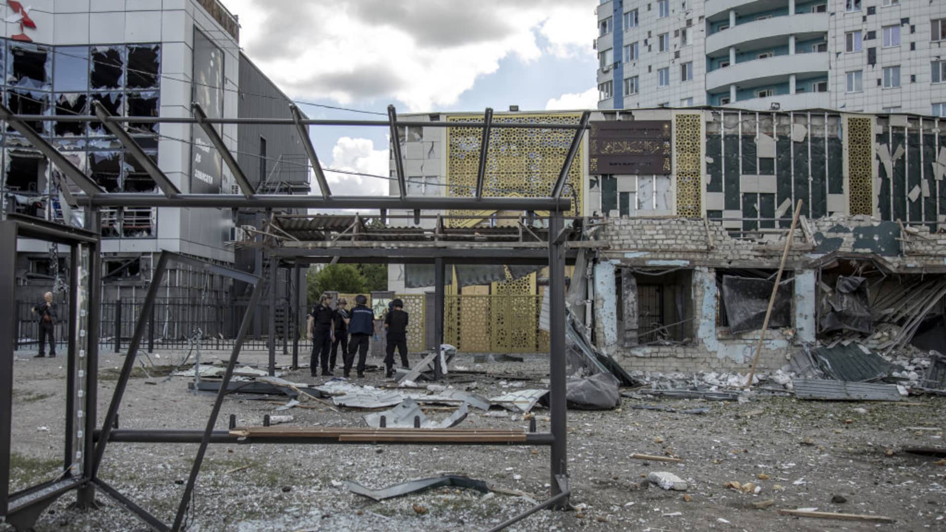 Policemen inspect the debris of a bus stand following a shelling attack that killed three while two more were people in the Saltivka neighborhood in Kharkiv City on July 20th, 2022.