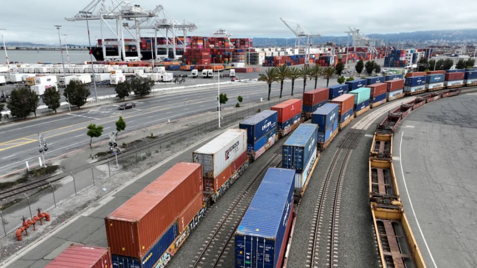 OAKLAND, CALIFORNIA - JULY 21: In an aerial view, shipping containers sit idle on a train at the Port of Oakland on July 21, 2022 in Oakland, California. Truckers protesting California labor law Assembly Bill 5 (AB5) have shut down operations at the Port of Oakland after blocking entrances to container terminals at the port for the past four days. An estimated 70,000 independent truckers in California are being affected by the state AB5 bill, a gig economy law passed in 2019 that made it difficult for compa