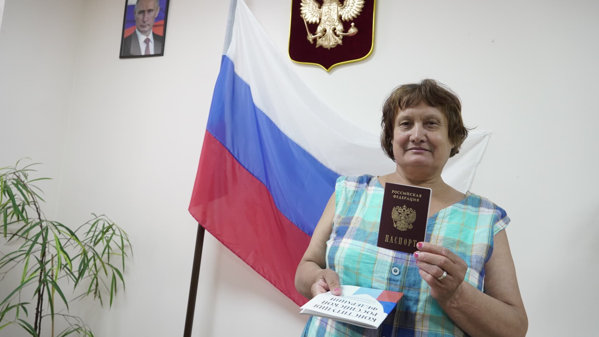 People arrive to receive Russian passports at a centre in Kherson after Russian President Vladimir Putin signed decree to make it easier for residents of Kherson and Melitopol regions to get passports, in Kherson, Kherson Oblast, Ukraine on July 21, 2022. 