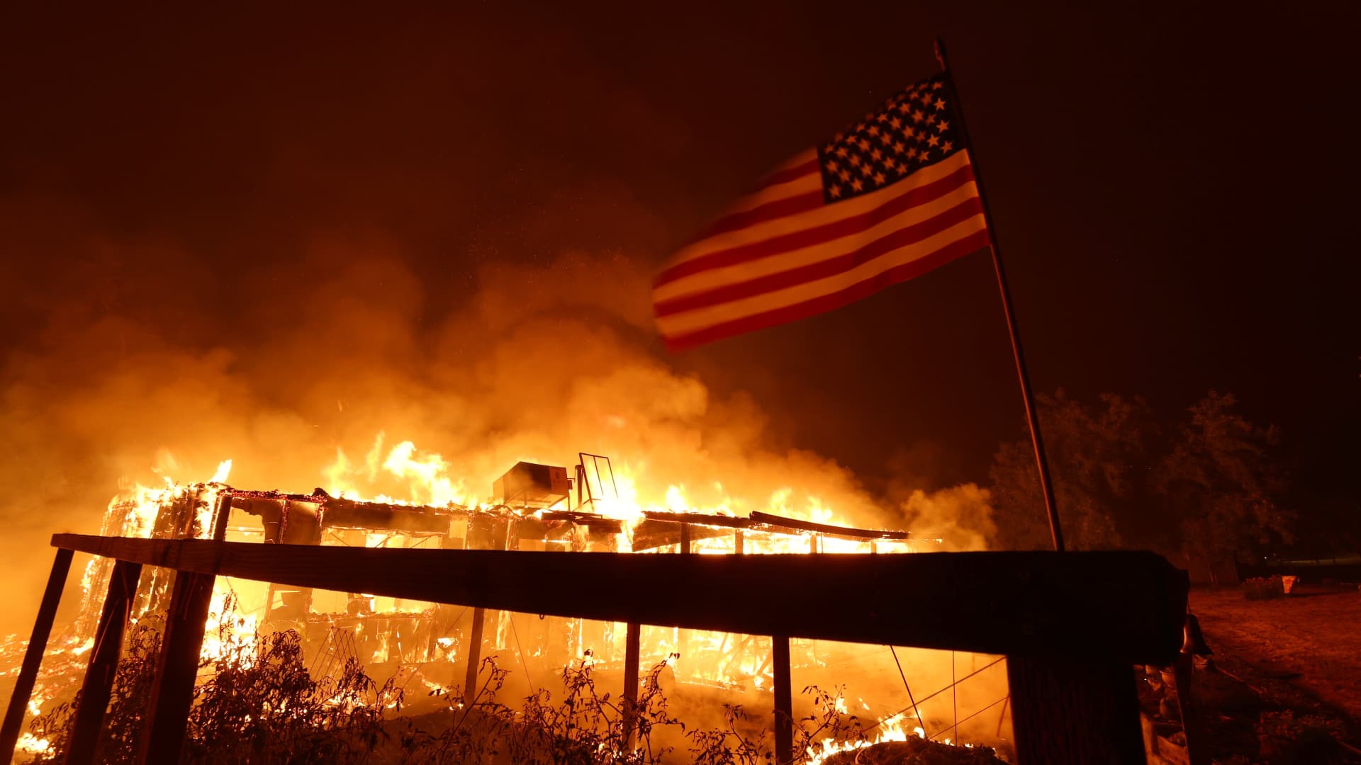 A home burns as the Oak Fire moves through the area on July 23, 2022 near Mariposa, California.