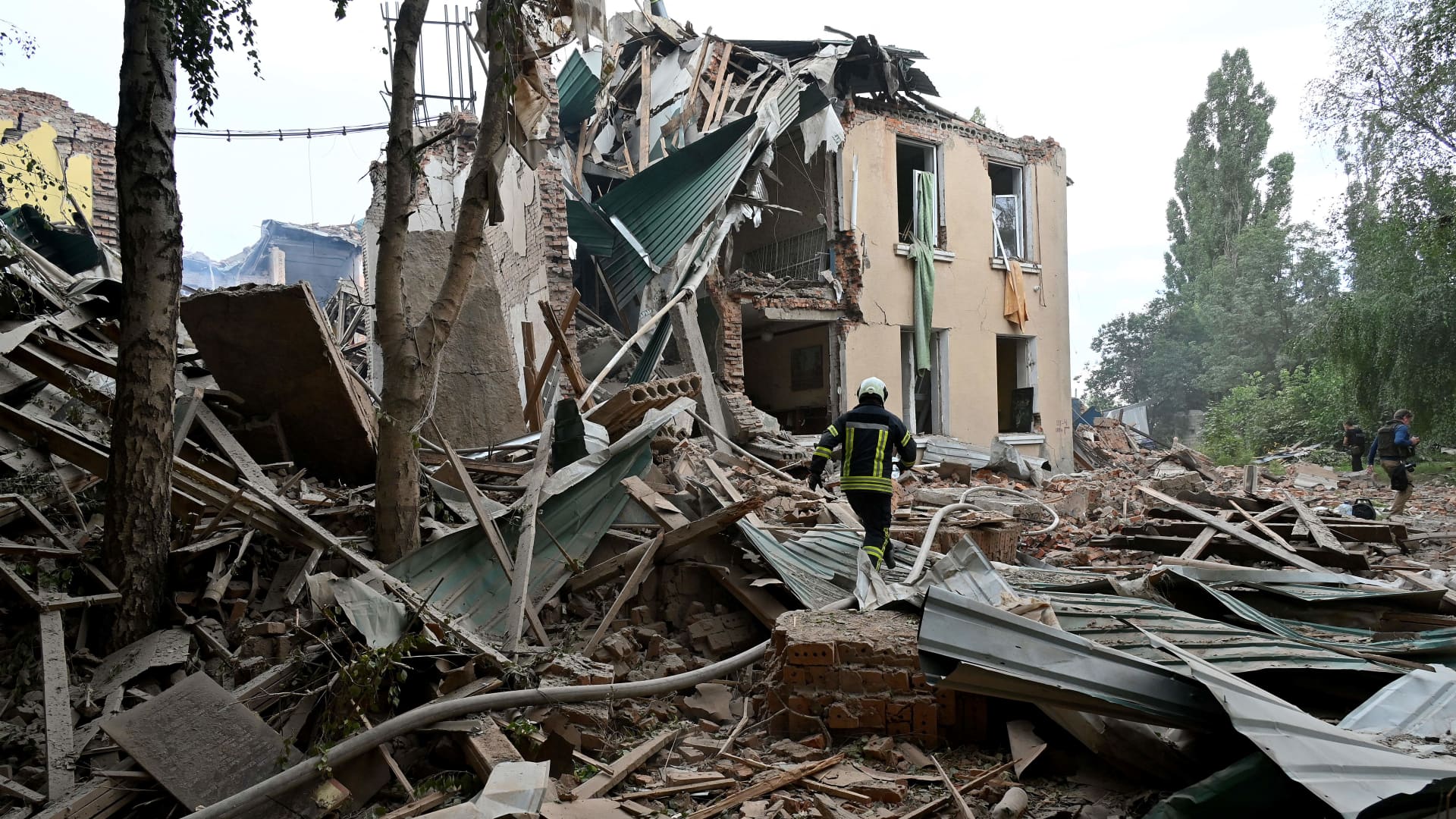 Rescue teams dig through the rubble of buildings destroyed in overnight attacks in a search for survivors, in the city of Chuhuiv, Kharkiv region, on July 25, 2022, amid the Russian invasion of Ukraine.