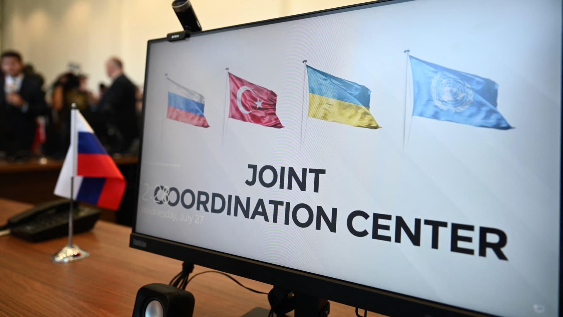 This photograph taken on July 27, 2022 shows a computer screen displaying Russian, Turkish, Ukrainian and United Nations's flags at the opening of the Joint Coordination Centre (JCC) for Ukrainian grain exports in Istanbul on July 27, 2022.