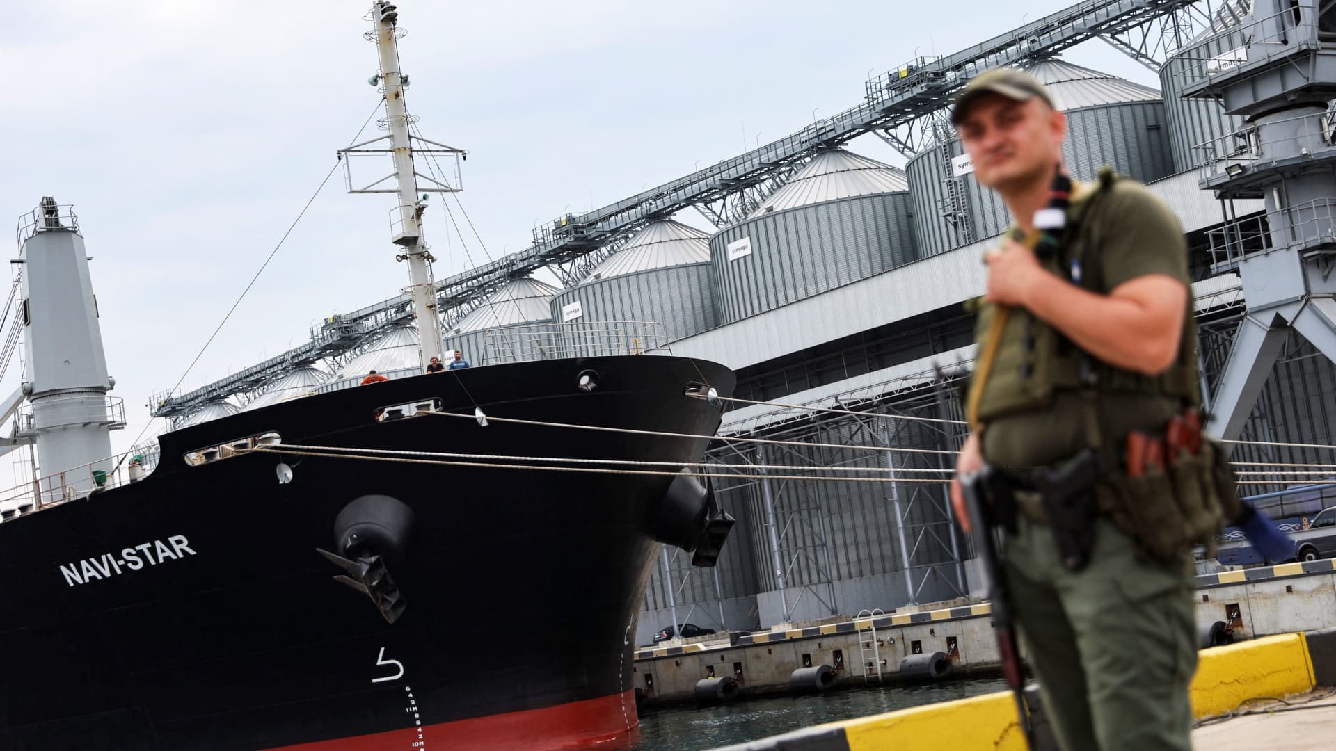 A Ukrainian serviceman stands in front of silos of grain from Odesa Black Sea port, before the shipment of grain as the government of Ukraine awaits signal from UN and Turkey to start grain shipments, amid Russia's invasion of Ukraine, in Odesa, Ukraine July 29, 2022. REUTERS/Nacho Doce