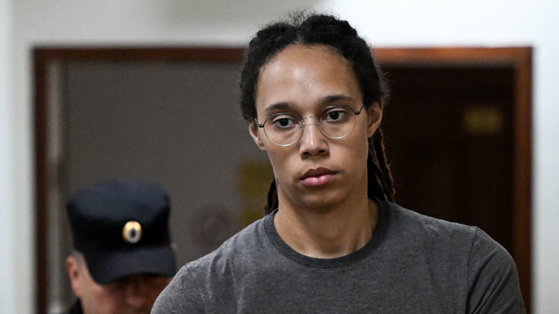 US' Women's National Basketball Association (NBA) basketball player Brittney Griner, who was detained at Moscow's Sheremetyevo airport and later charged with illegal possession of cannabis, stands inside a defendants' cage before a court hearing in Khimki outside Moscow, on August 4, 2022. 