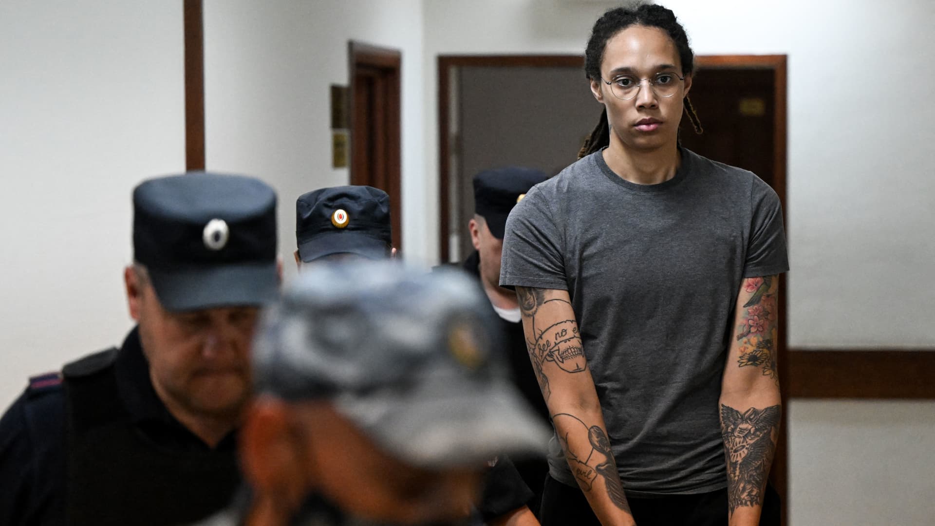US' Women's National Basketball Association (NBA) basketball player Brittney Griner, who was detained at Moscow's Sheremetyevo airport and later charged with illegal possession of cannabis, stands inside a defendants' cage before a court hearing in Khimki outside Moscow, on August 4, 2022. -