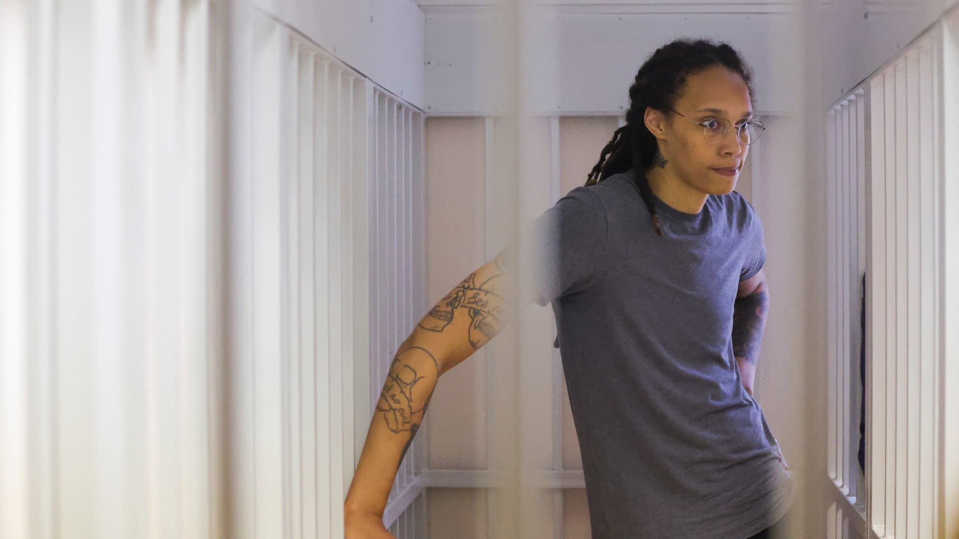 US' Women's National Basketball Association (NBA) basketball player Brittney Griner, who was detained at Moscow's Sheremetyevo airport and later charged with illegal possession of cannabis, waits for the verdict inside a defendants' cage before a court hearing in Khimki outside Moscow, on August 4, 2022. 