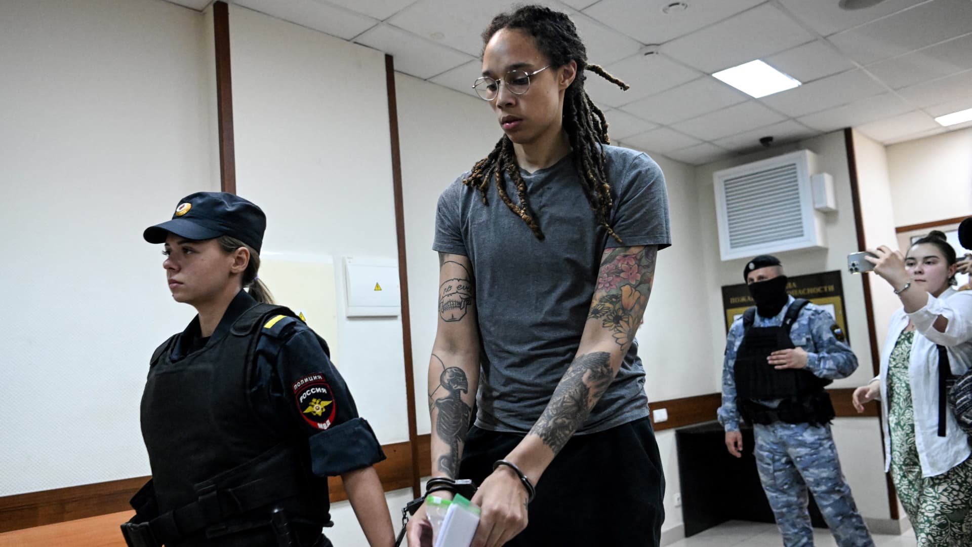US' Women's National Basketball Association (NBA) basketball player Brittney Griner, who was detained at Moscow's Sheremetyevo airport and later charged with illegal possession of cannabis, waits for the verdict inside a defendants' cage before a court hearing in Khimki outside Moscow, on August 4, 2022. 