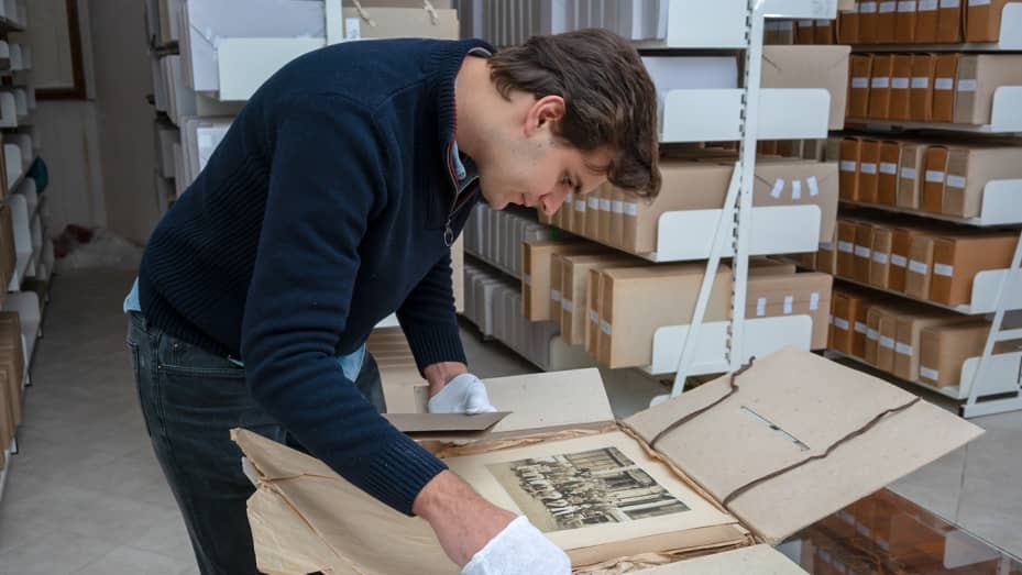 William Rudolf Lobkowicz examining old family photographs in the Lobkowicz Archives.