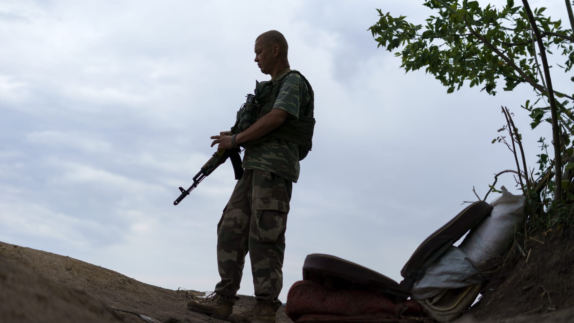 Ukrainian soldier Igor Ryazantsev with the Dnipro-1 regiment keeps watch outside his tent during a period of relative calm around their position near Sloviansk, Donetsk region, eastern Ukraine, Friday, Aug. 5, 2022. Members of the unit believe a Russian advance could be impending with the aim of seizing the strategic city.