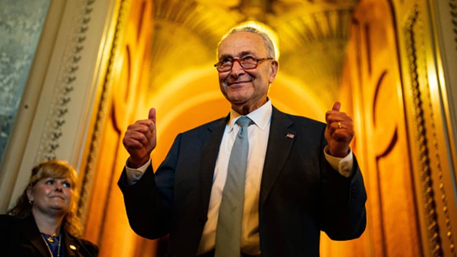 WASHINGTON, DC - AUGUST 07: Senate Majority Leader Chuck Schumer (D-NY) gestures, walking out of the Senate Chamber, celebrating the passage of the Inflation Reduct Act at the U.S. Capitol on Sunday, Aug. 7, 2022 in Washington, DC. The Senate worked overnight Saturday into Sunday as they moved toward final passage of Senate budget reconciliation deal, which Senate Democrats have named The Inflation Reduction Act of 2022. The final vote was 51-50, with the tie-breaking vote being cast by Vice President Kamal