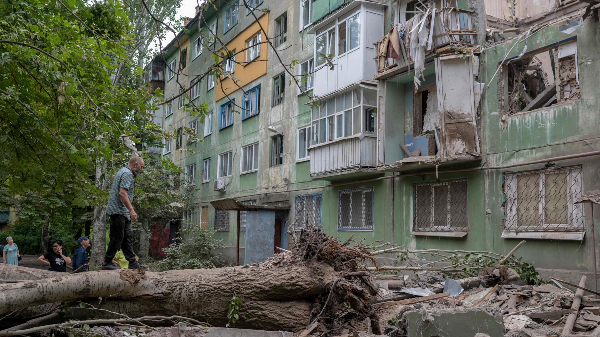 Local residents look at the damages after an early morning Russian forces' strike in Kostiantynivka, eastern Ukraine, amid the Russian invasion of Ukraine.