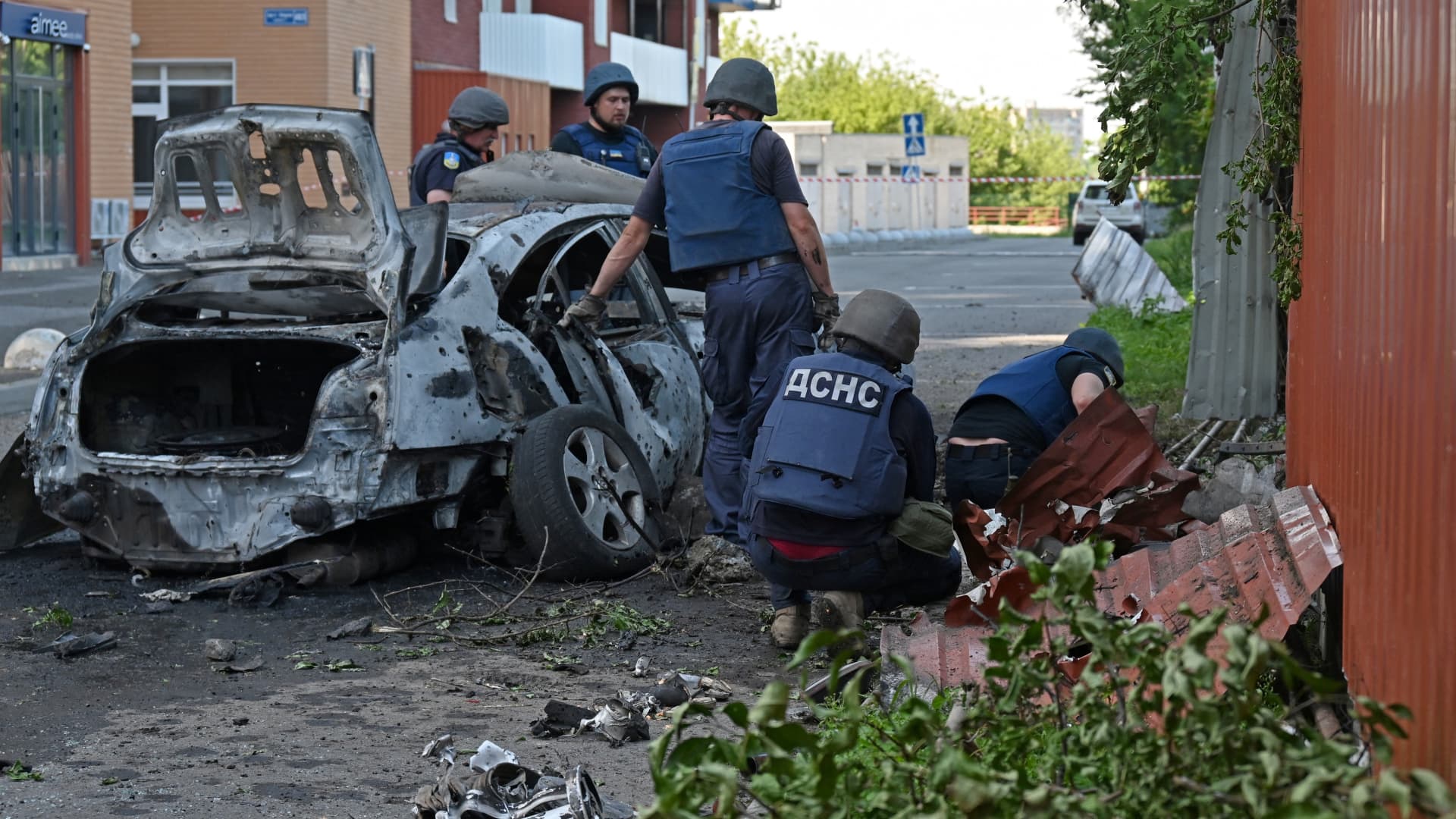Deminers examine the site of a reported cluster munition fall after a rocket attack on a residential area in northern Kharkiv, on August 8, 2022, amid the Russian military invasion launched on Ukraine.