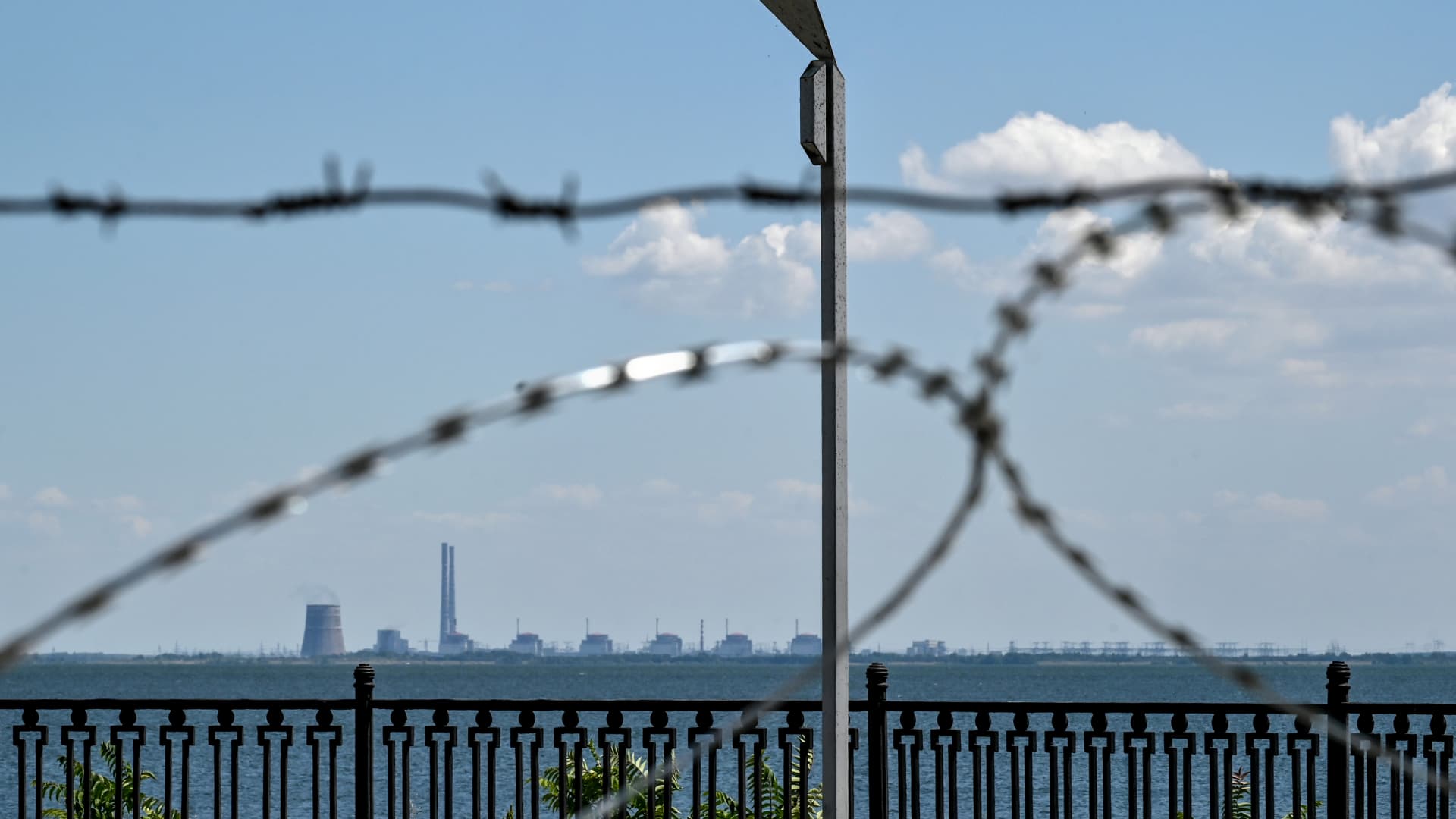 The Zaporizhzhia Nuclear Power Plant in Enerhodar, Zaporizhzhia Region, is seen through barbed wire on the embankment in Nikopol, Dnipropetrovsk Region, central Ukraine.