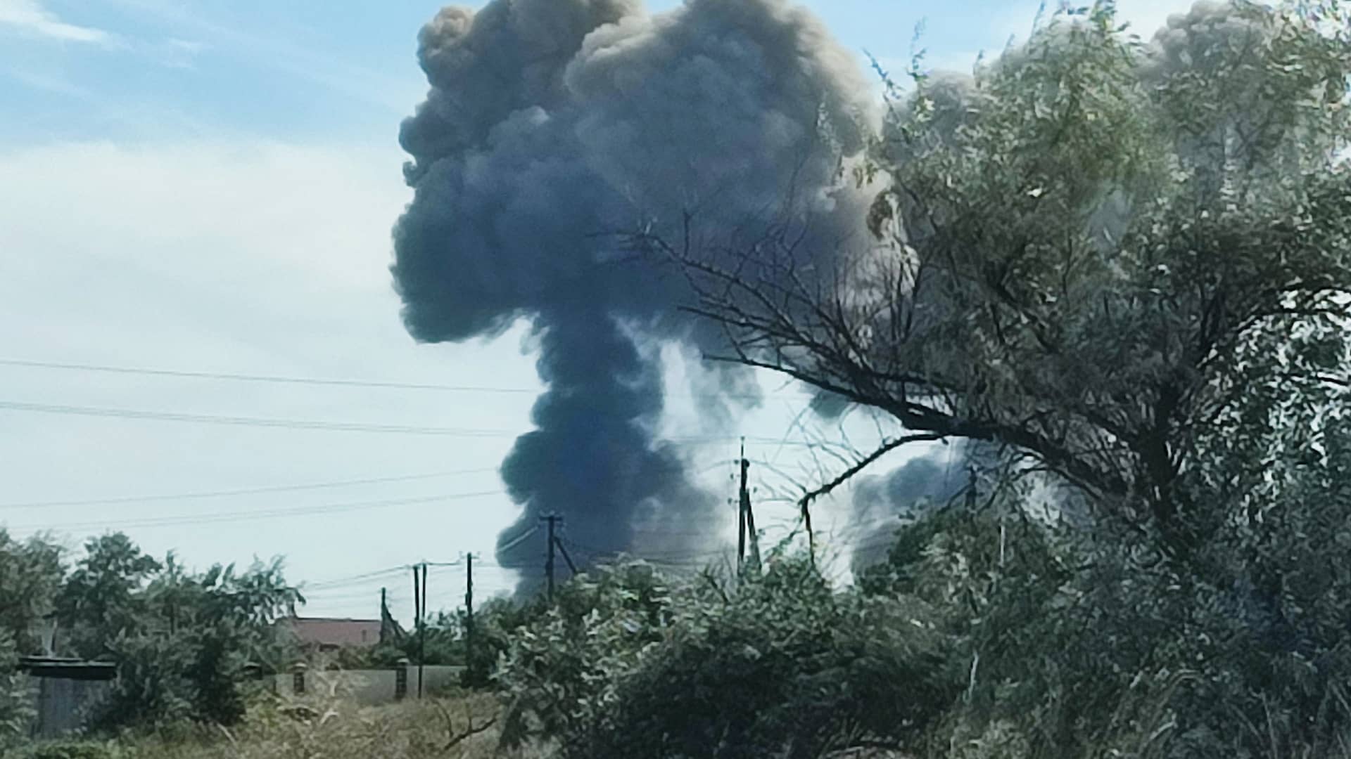 Smoke rises after explosions were heard from the direction of a Russian military airbase near Novofedorivka, Crimea, on Aug. 9, 2022.