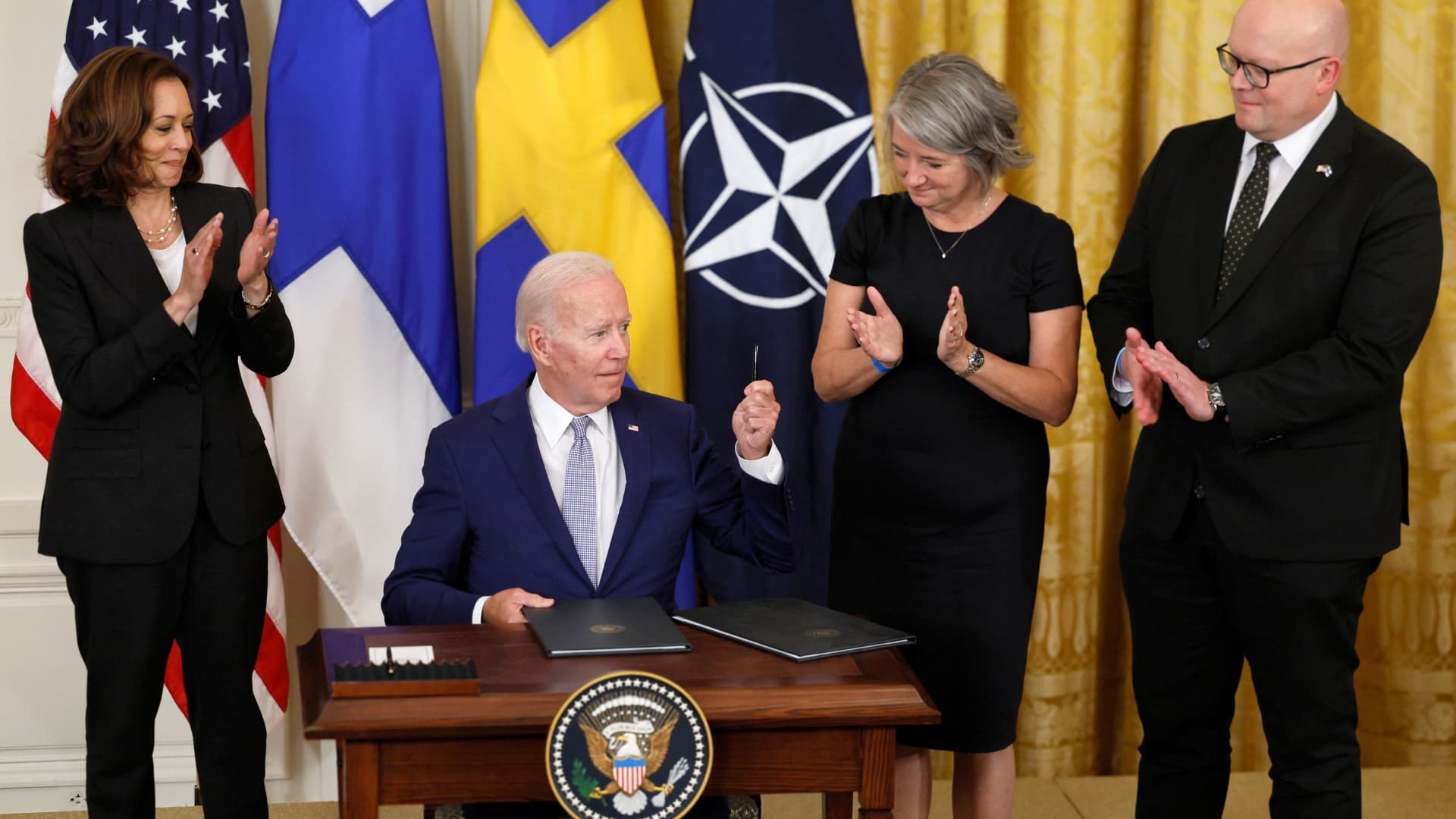 U.S. President Joe Biden, alongside Vice President Kamala Harris, Swedish ambassador to the U.S. Karin Olofsdotter and Finnish ambassador to the U.S. Mikko Hautala, signs documents endorsing Finland's and Sweden's accession to NATO, in the East Room of the White House, in Washington, August 9, 2022.