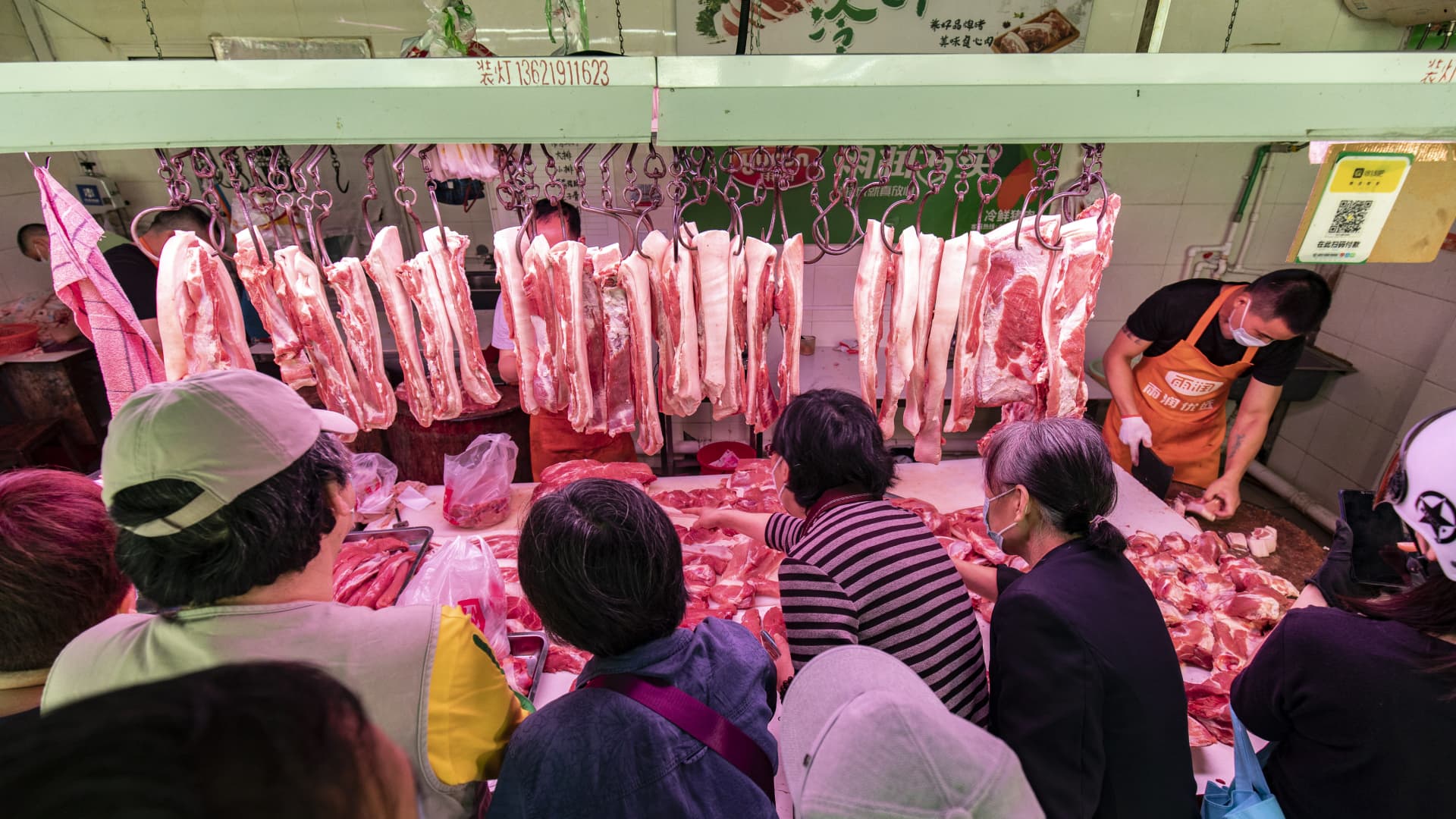 Customers buying pork at a food market in Shanghai, China. Prices of pork, a food staple in China, rose by 20.2% in July 2022 compared to a year ago, official data showed.