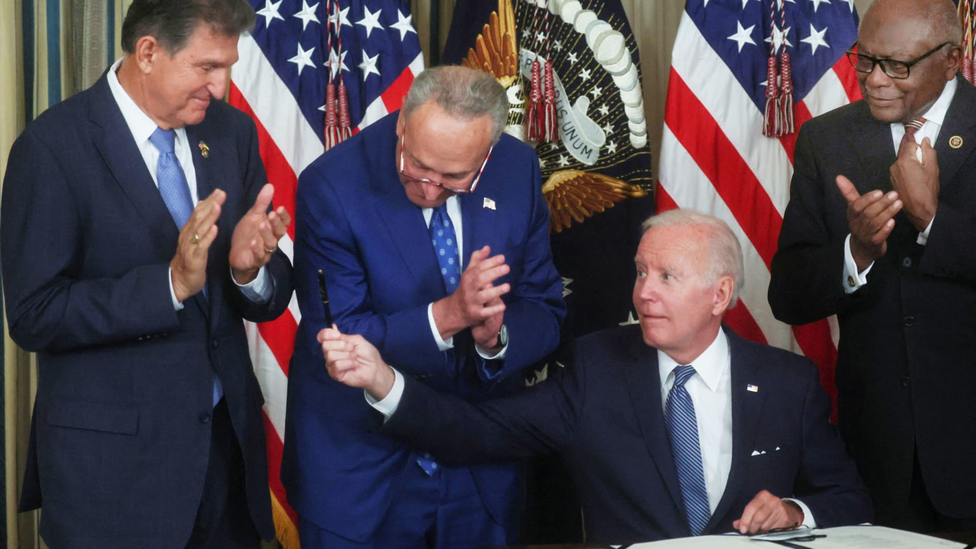 Biden signs Inflation Reduction Act into law, setting 15% minimum corporate tax rate