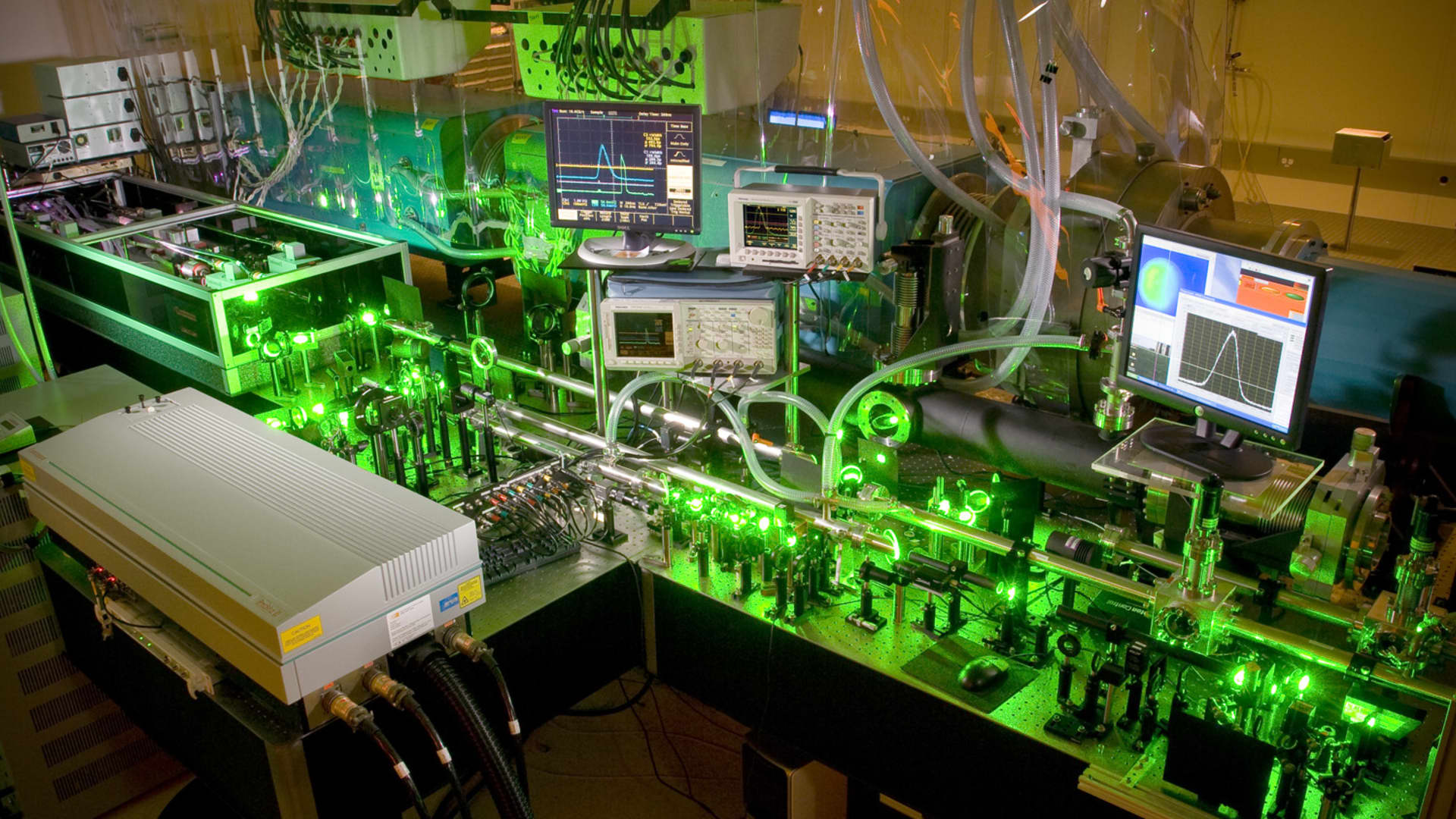 Inside what's called the amplifier bay of the Texas Petawatt Laser, where the energy of a laser pulse is boosted. The green light are the pump lasers that amplify or boost the energy of the main laser.