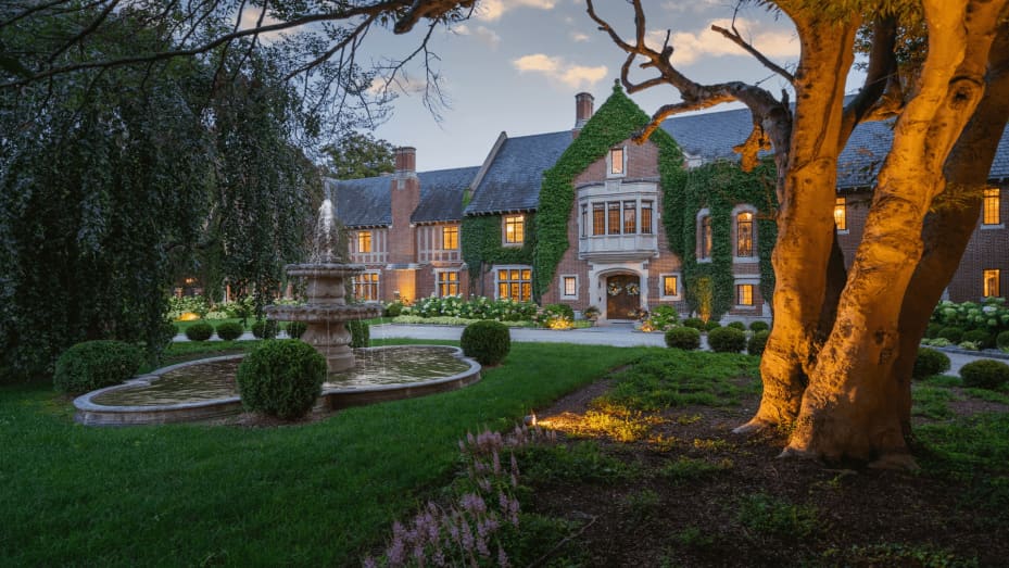 The private drive leads to lush landscaping and a fountain at the home's main entry.