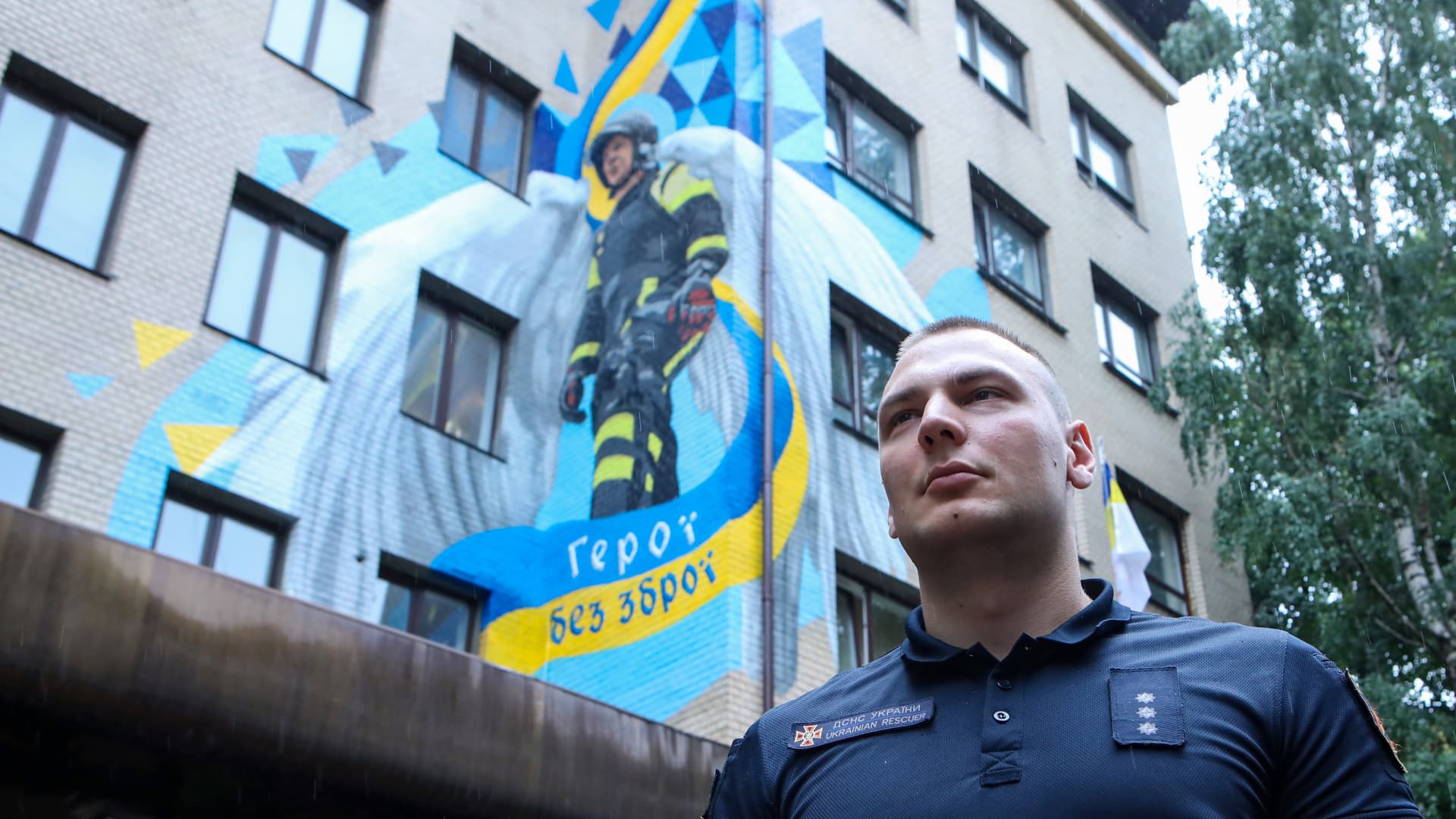 Head of the Mountain Rescue Department of the Kyiv Garrison Yurii Pletnov, who is the prototype of the Heroes Without Weapons mural by street artists Vitalii Hidevan and Olena Noina, stands before the artwork painted on the facade of an administrative building of the State Emergency Service (DSNS), Kyiv, capital of Ukraine. This photo cannot be distributed in the Russian Federation.