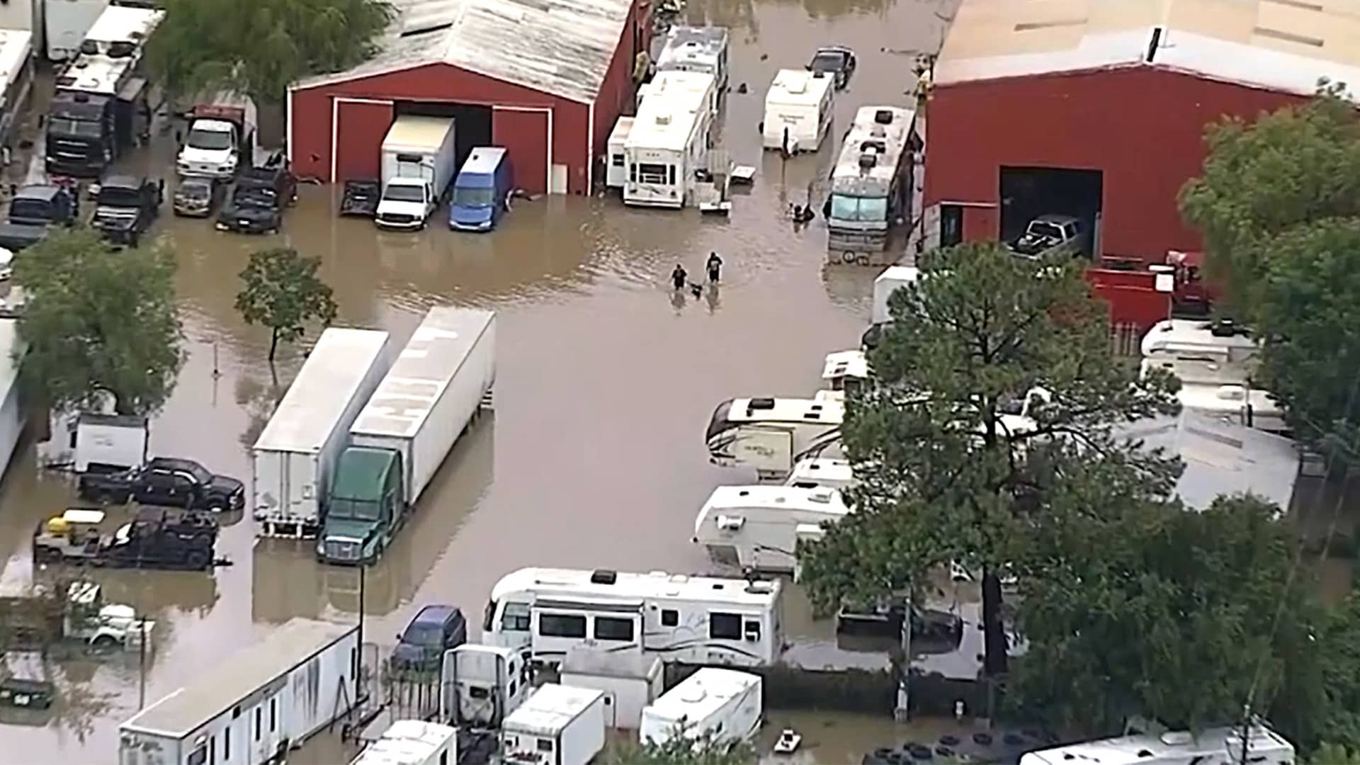 Residents navigate floodwaters after heavy flooding in the Dallas metro area submerged roads and entire neighborhoods, in Seagoville, Texas, U.S., August 22, 2022, in this still image taken from video.