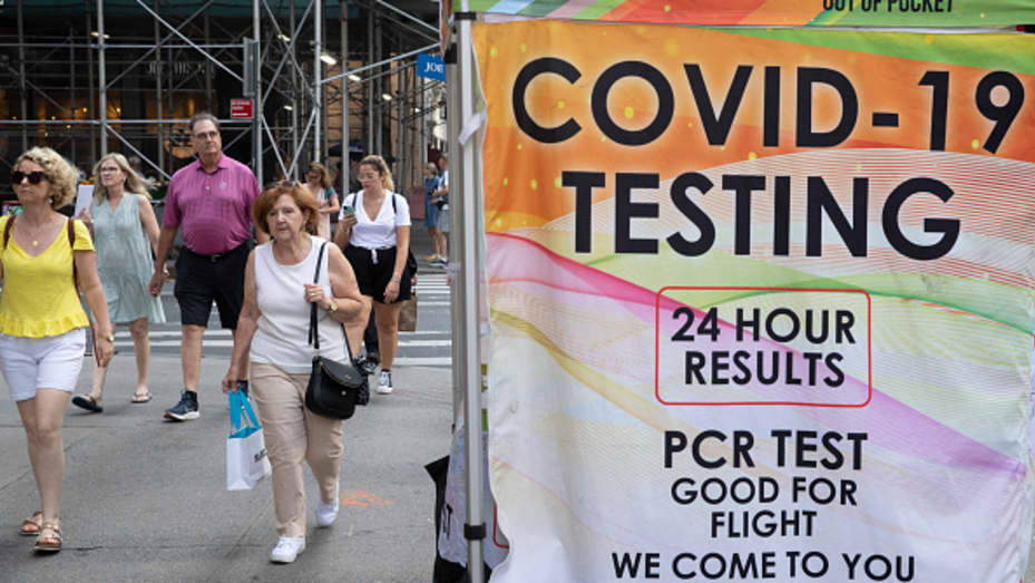 People walk past a COVID-19 walk up testing site on July 28, 2022 in New York City.