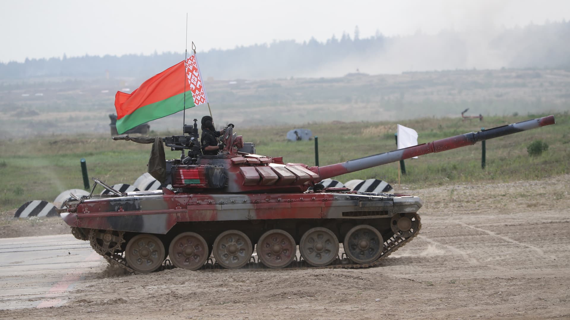 Team of Belarus on a T-72 B3 battle tank with Belarussian flag at a military polygon, on August 27, 2022, in Alabino, outside of Moscow, Russia.