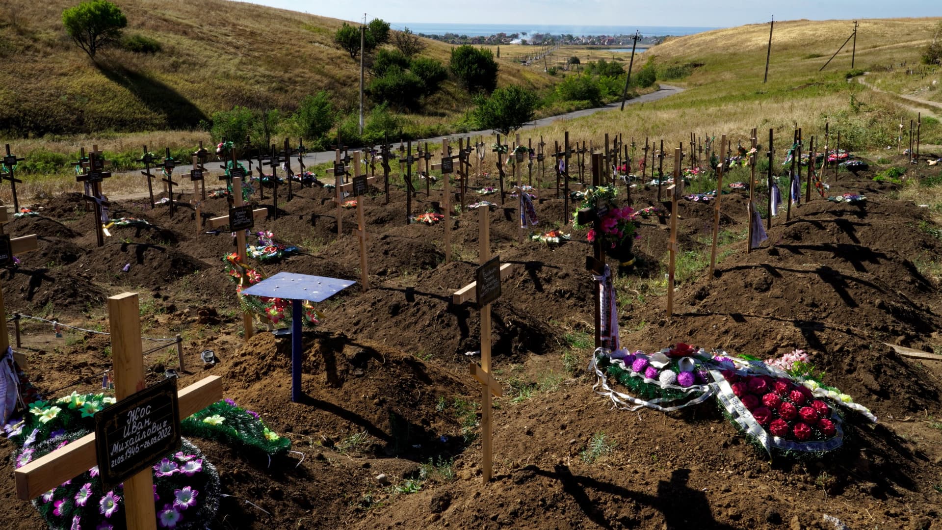 Graves are seen at a cemetery in the settlement of Vinogradnoye outside Mariupol on September 8, 2022, amid the ongoing Russian military action in Ukraine.