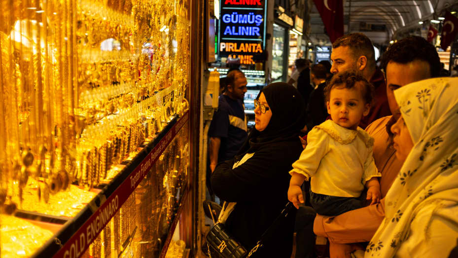 People browse gold jewelry in the window of a gold shop in Istanbul's Grand Bazaar on May 05, 2022 in Istanbul, Turkey. Gold prices ticked higher on Monday as the dollar hovered near recent lows, with investors' focus being on a key U.S. inflation reading as it could influence the size of the Federal Reserve's next interest-rate hike.