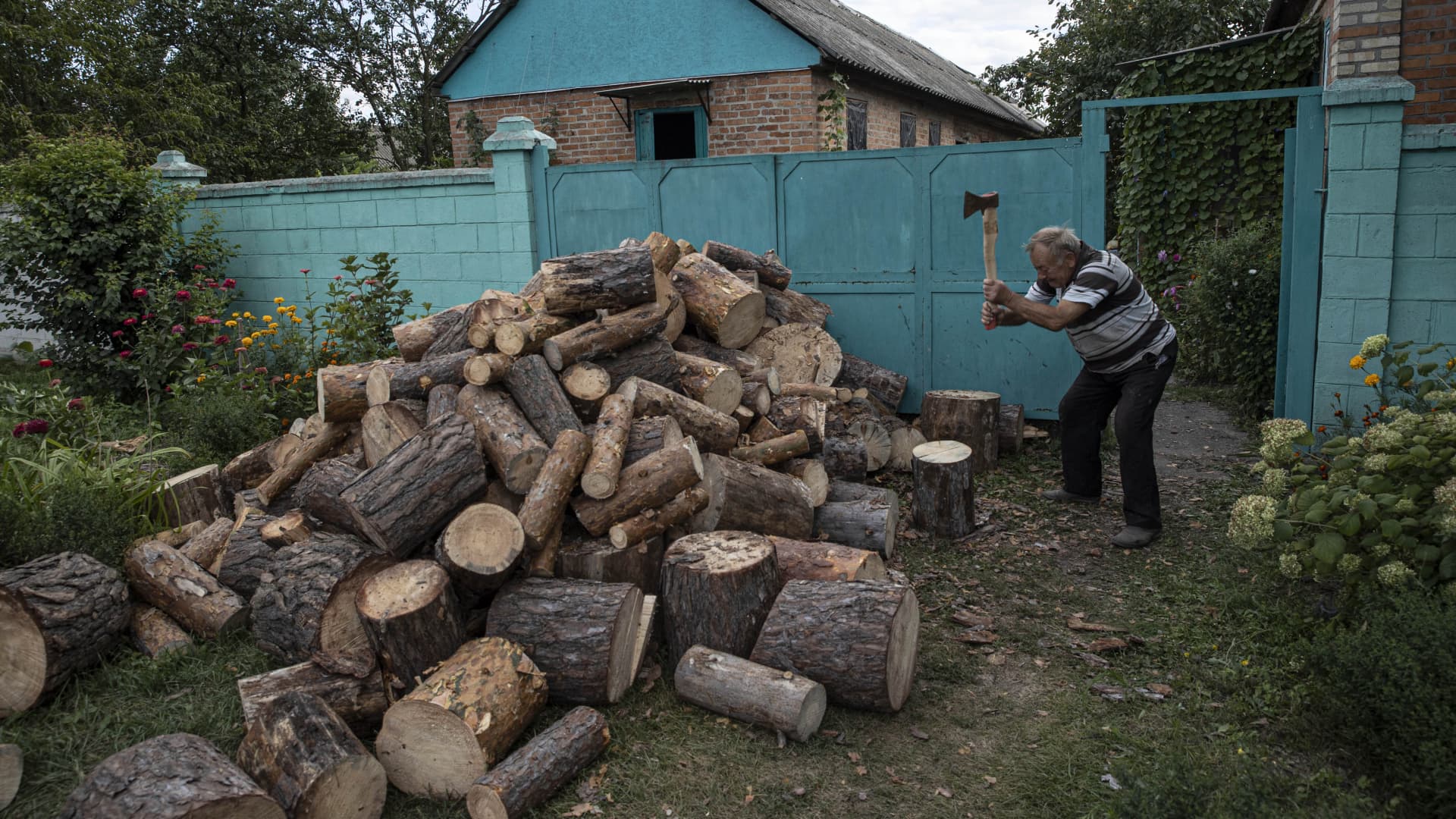 A Ukrainian man prepares for the cold winter and stocking up on firewood in Kharkiv, Ukraine, September 13, 2022.