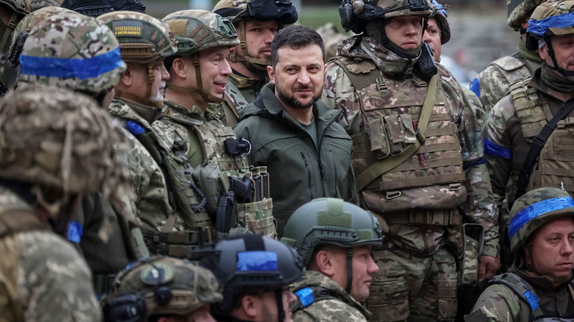 Ukraine's President Volodymyr Zelenskyy poses for a pictures with Ukrainian servicemen as he visits the town of Izium, recently liberated by Ukraine's armed forces, in the Kharkiv region of Ukraine on Sept. 14, 2022.