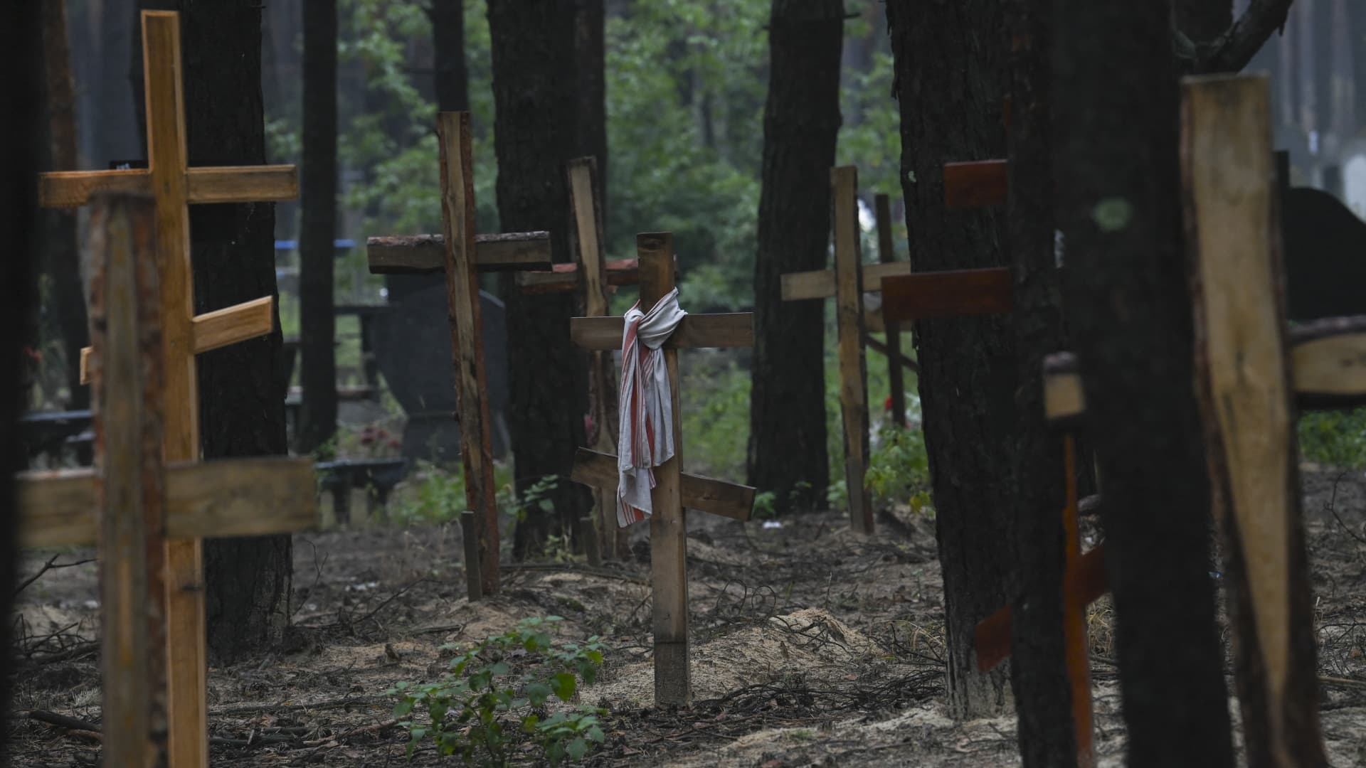This photograph taken eastern Ukraine on September 16, 2022 shows crosses at a burial site in a forest on the outskirts of Izyum.