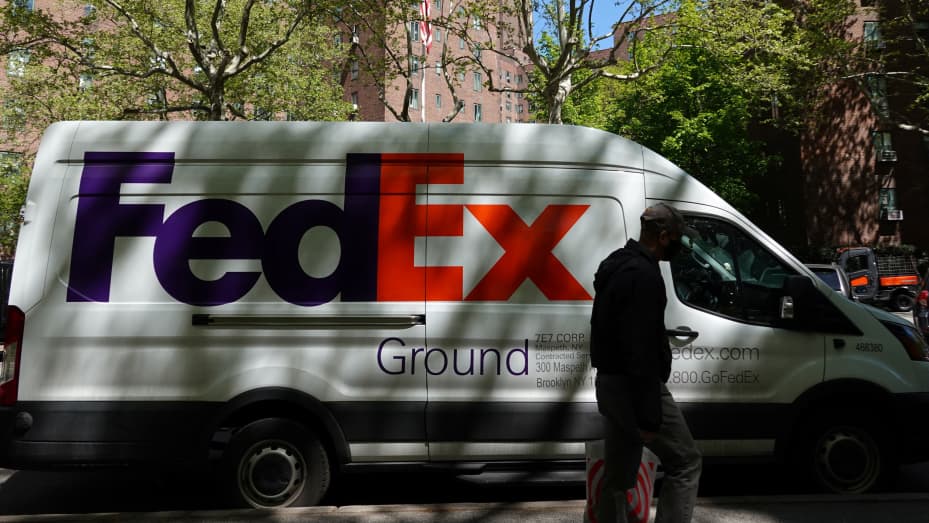 A person walks by a FedEx van in New York City, May 9, 2022.