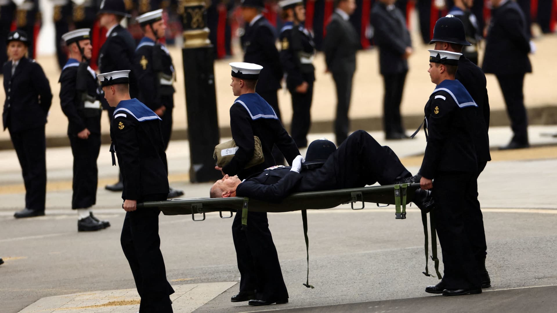 A policeman who collapsed being taken away outside Westminster Abbey on the day of the state funeral and burial of Britain's Queen Elizabeth, in London, Britain, September 19, 2022. 