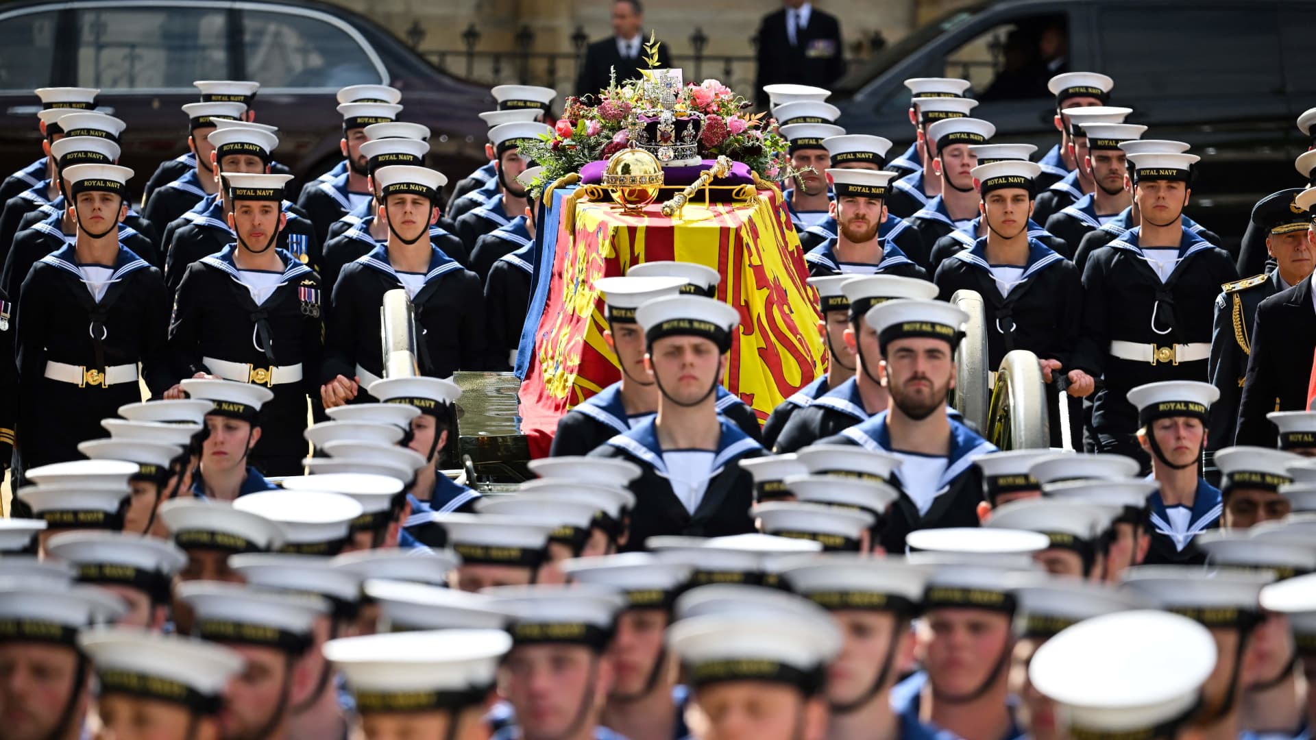 Royal Navy Sailors walk ahead and behind the coffin of Queen Elizabeth II, draped in the Royal Standard, as it travels on the State Gun Carriage of the Royal Navy from Westminster Abbey to Wellington Arch in London on September 19, 2022, after the State Funeral Service of Britain's Queen Elizabeth II.