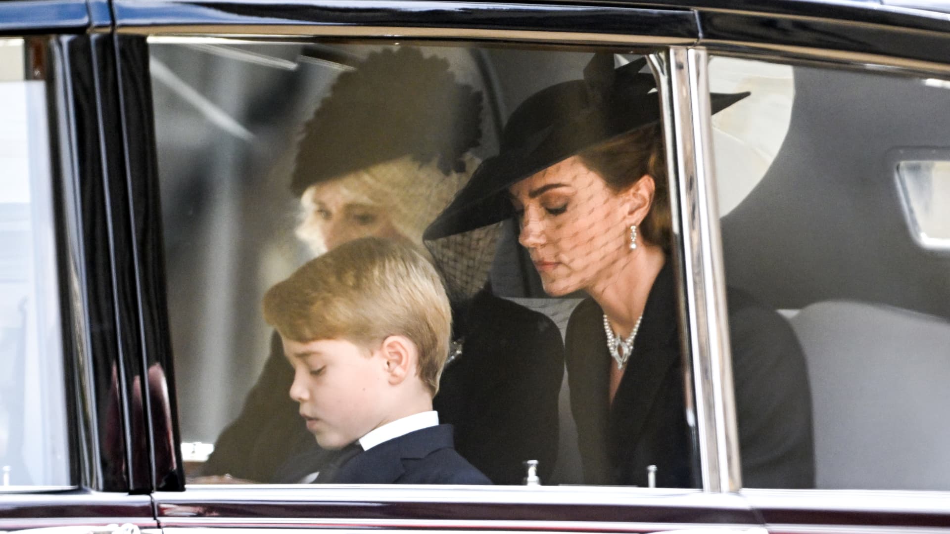 (L-R) Camilla, Queen Consort, Prince George of Wales and Catherine, Princess of Wales during the State Funeral of Queen Elizabeth II at Westminster Abbey on September 19, 2022 in London, England.
