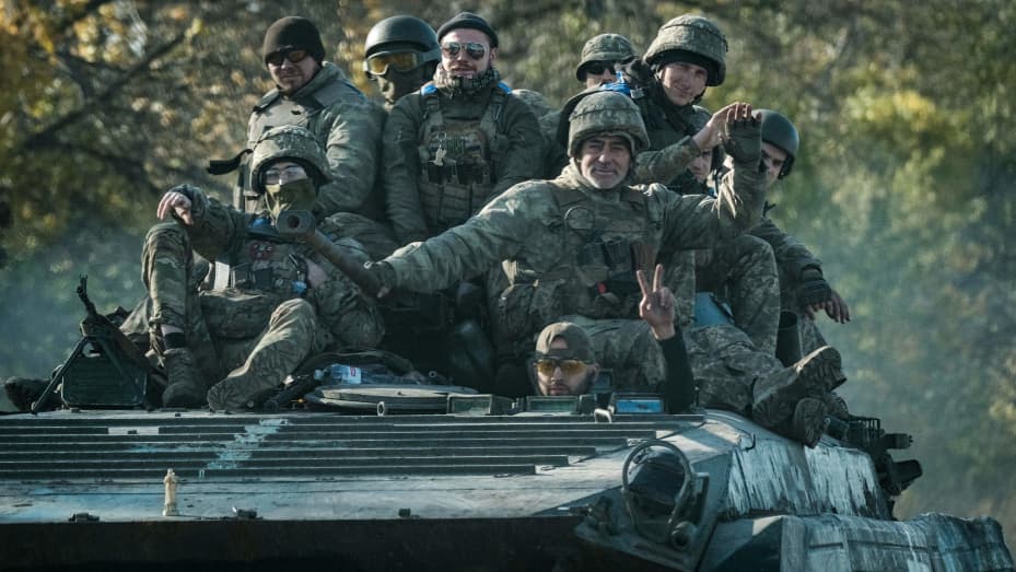 Ukrainian soldiers ride on an armored vehicle in Novostepanivka, Kharkiv region, on September 19, 2022.