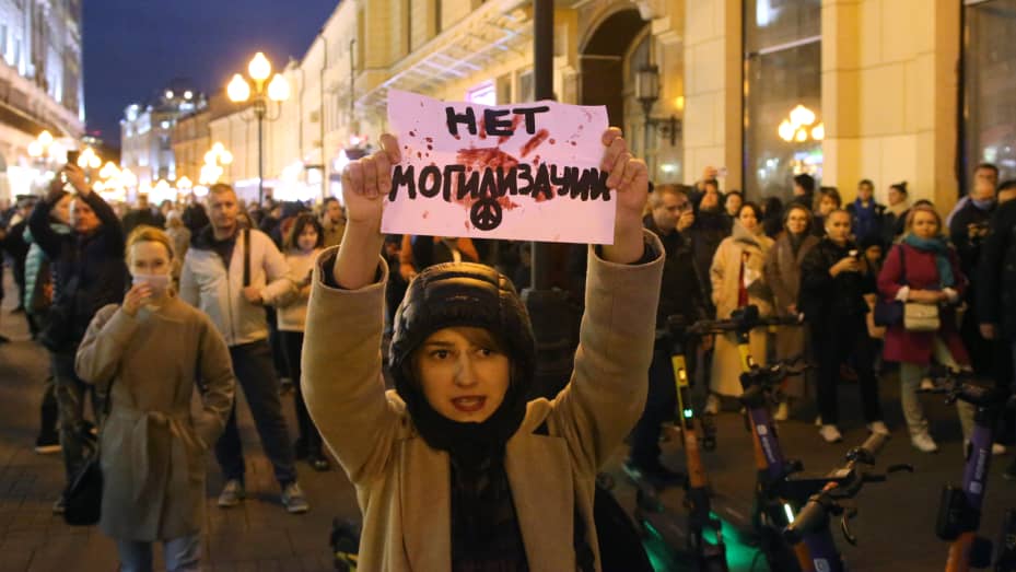 An activist participates in an unsanctioned protest at Arbat Street Sept. 21, 2022 in Moscow, Russia. The sign plays on the word mobilization as "No burialization."