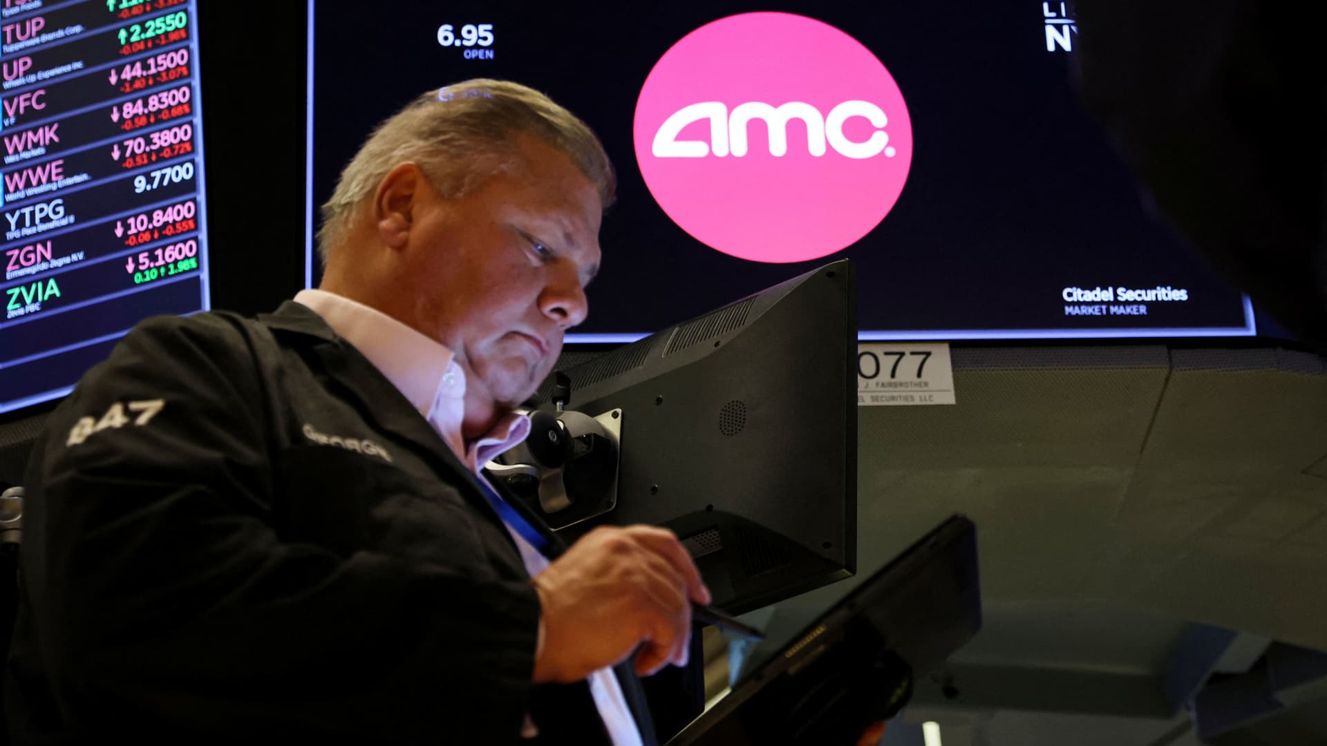 AMC shares slide more than 30% after theater chain announces plan to sell additional stock