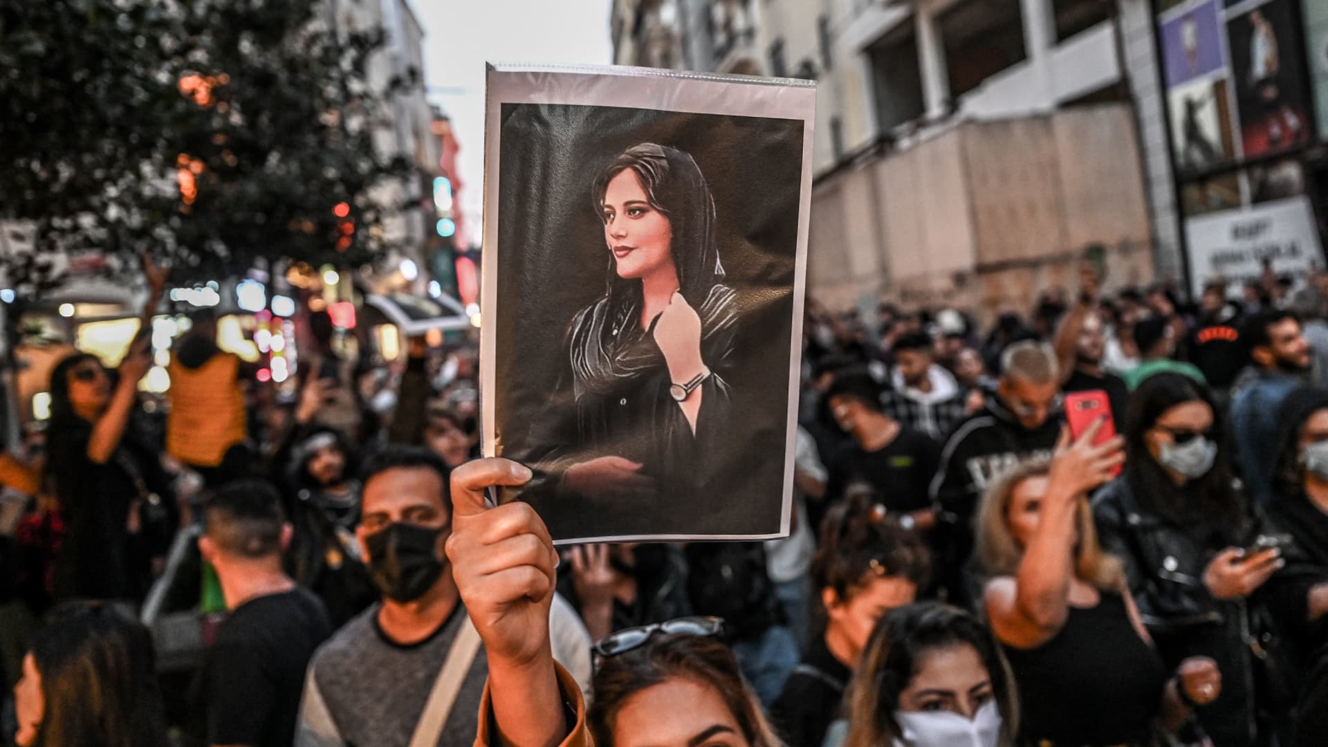 A protester holds a portrait of Mahsa Amini during a demonstration in support of Amini, a young Iranian woman who died after being arrested in Tehran by the Islamic Republic's morality police, on Istiklal avenue in Istanbul on Sept. 20, 2022.