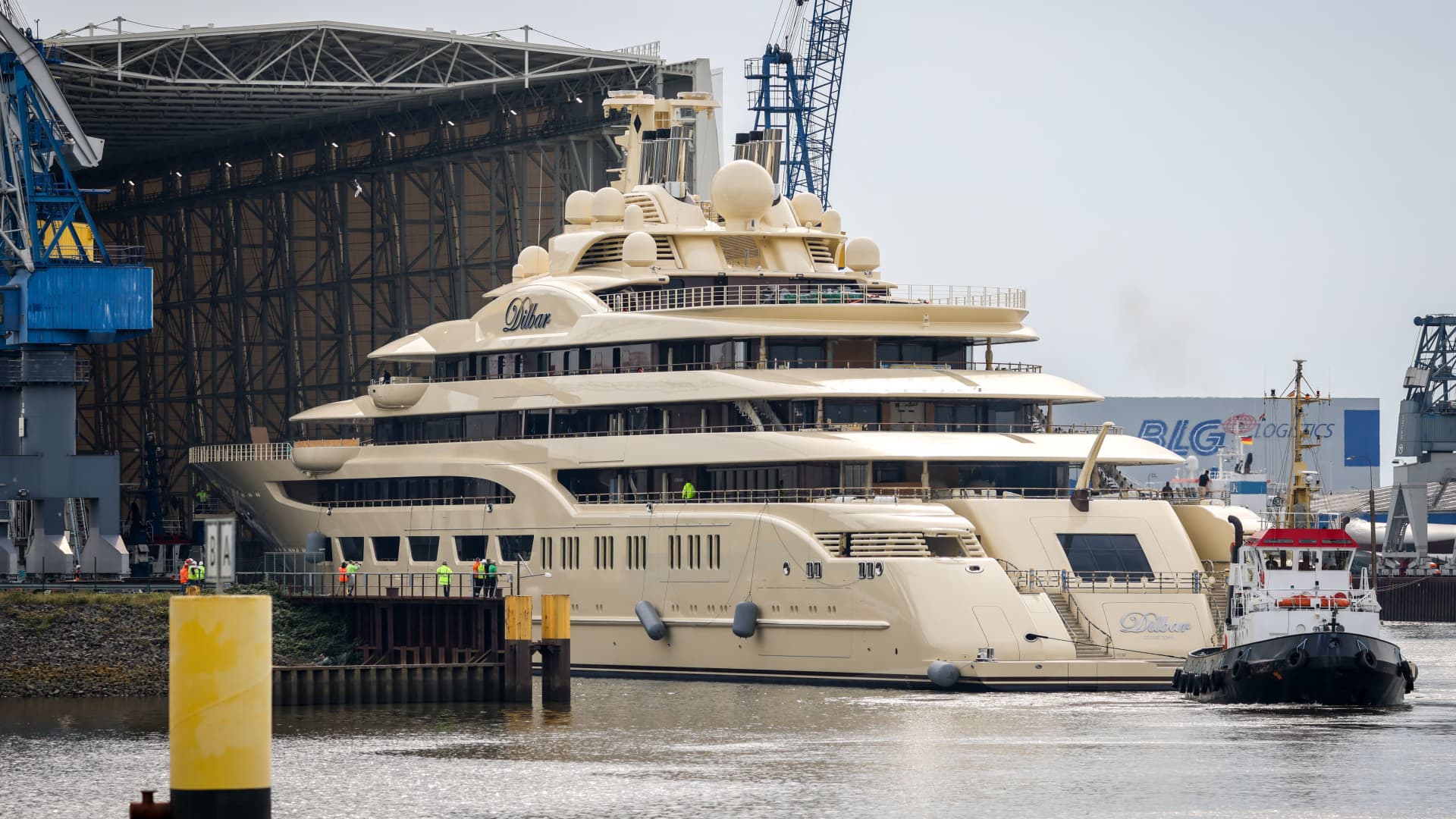 The super-yacht Dilbar is pulled into a covered floating dock of Luerssen shipyards on the Weser river at the harbour of Bremen on September 23, 2022. - The 156-meter-yacht had stayed since October 2021 for repairs in dry dock at a German shipbuilding company at Hamburg's harbour, northern Germany, and is considered the world's biggest by tonnage. It is owned the Russian billionaire Alisher Usmanov, 68, who has been among dozens of Russian oligarchs hit by punishing Western sanctions over Russian President Vladimir Putin's invasion of Ukraine. (Photo by FOCKE STRANGMANN / AFP) (Photo by FOCKE STRANGMANN/AFP via Getty Images)